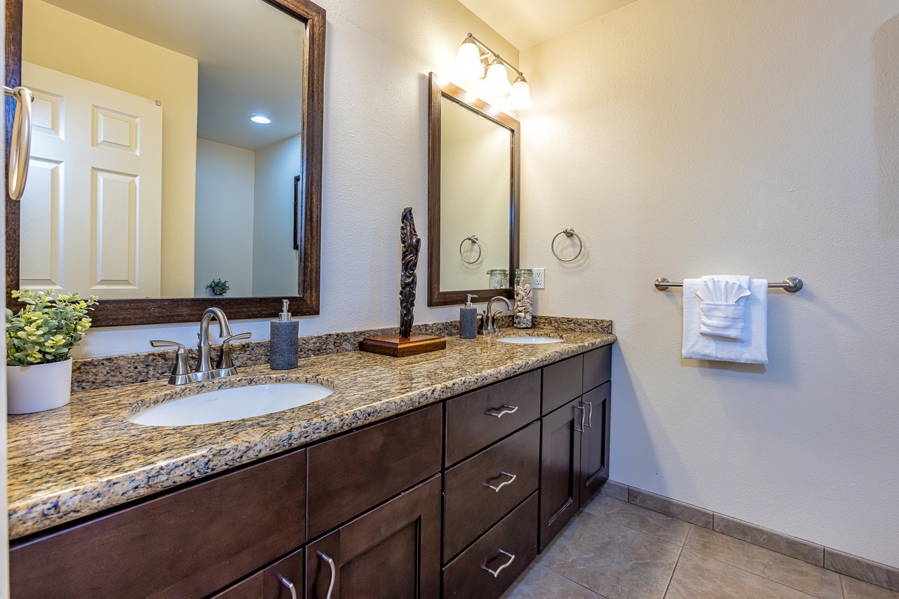 Unwind in your spa-like dual-vanity bathroom, where rich granite counters and warm wood tones create a welcoming space to start your mornings at ease.