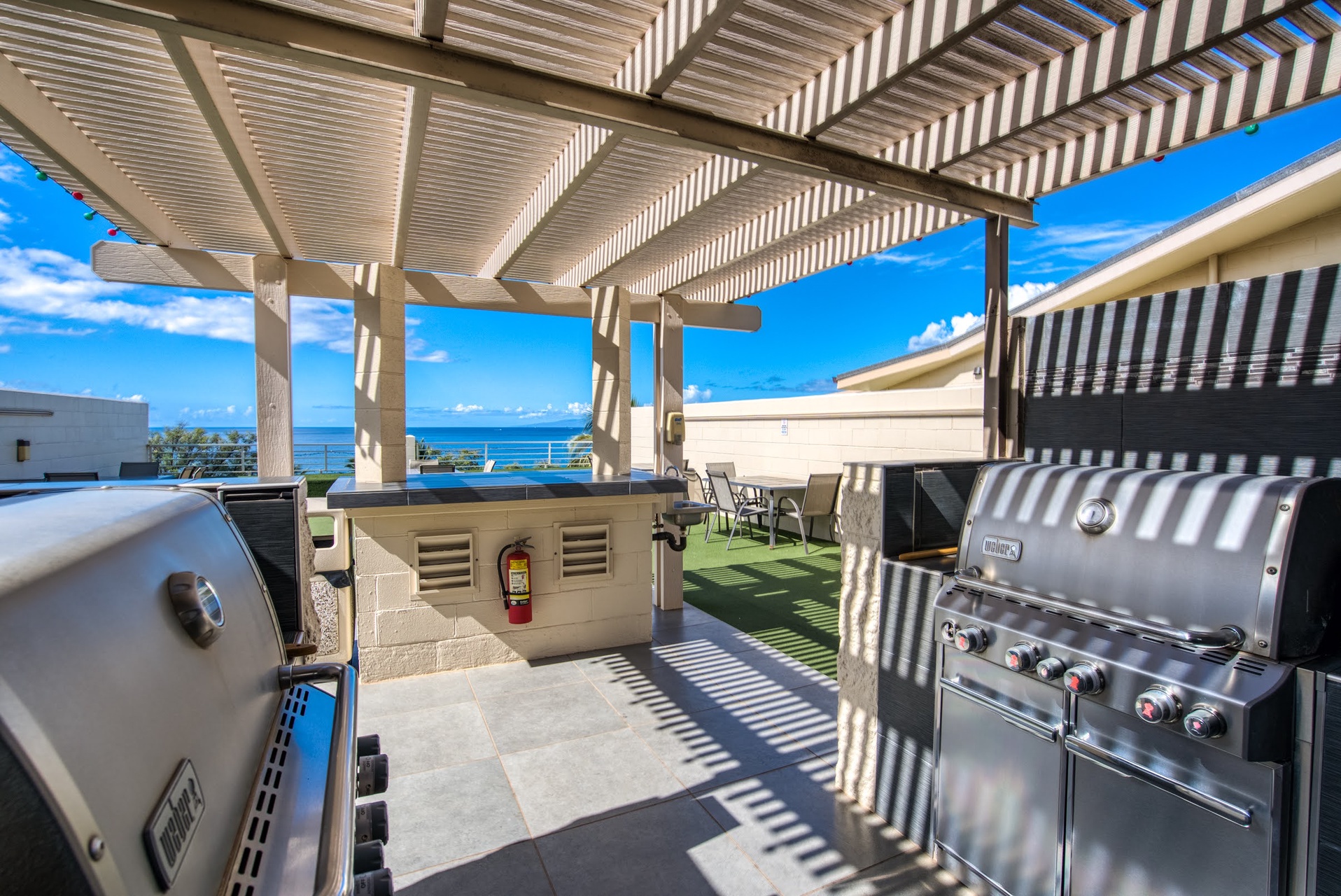 Ocean views await from this covered rooftop terrace featuring dual grills for memorable cookouts and alfresco dining under blue skies.