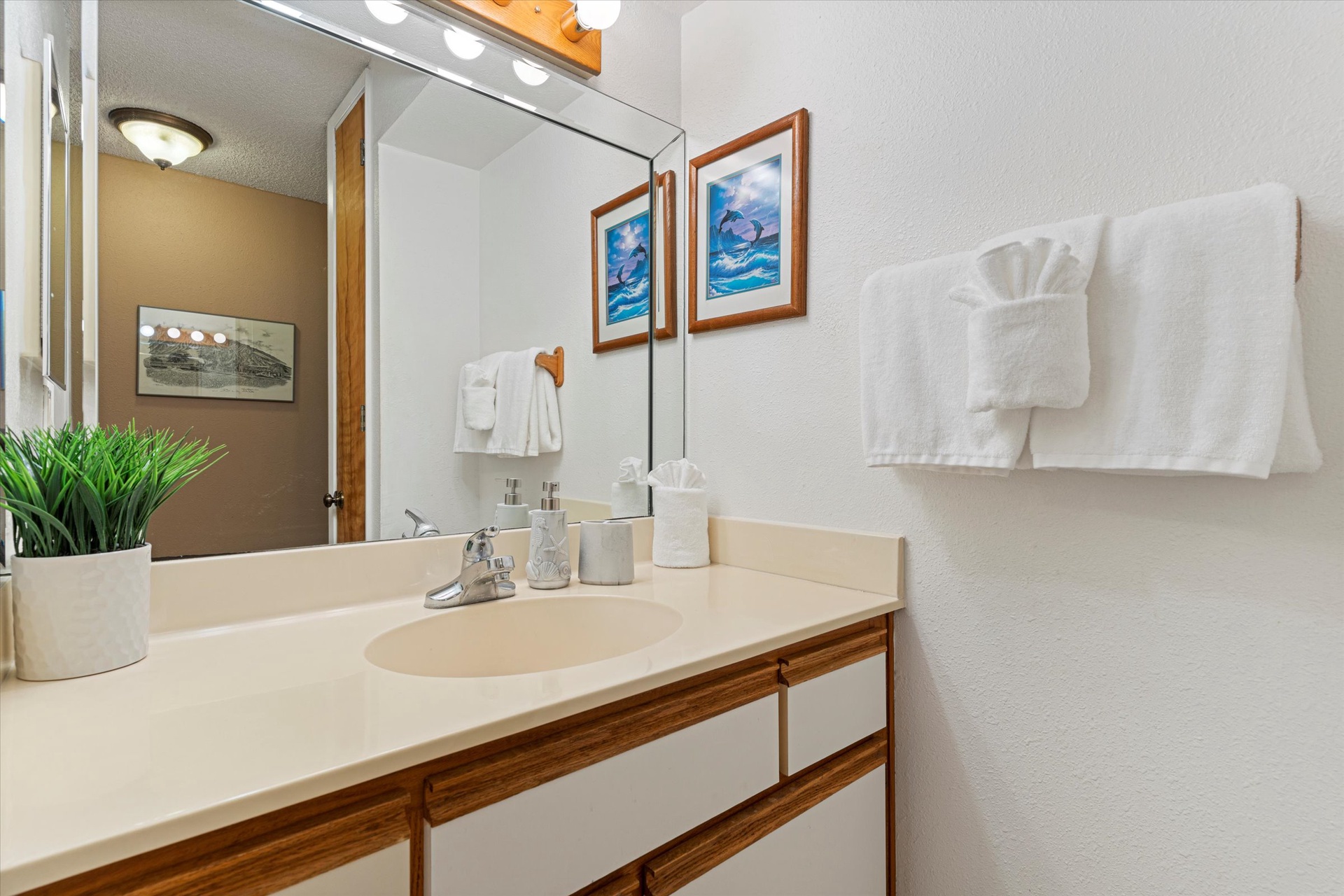 Your private bathroom features fresh linens, coastal artwork, and all the essentials you'll need to feel right at home during your stay.