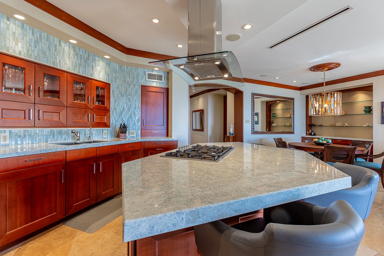 Step into your gourmet kitchen with a chef's-grade gas cooktop, and rich wood cabinetry—perfect for preparing memorable meals together.