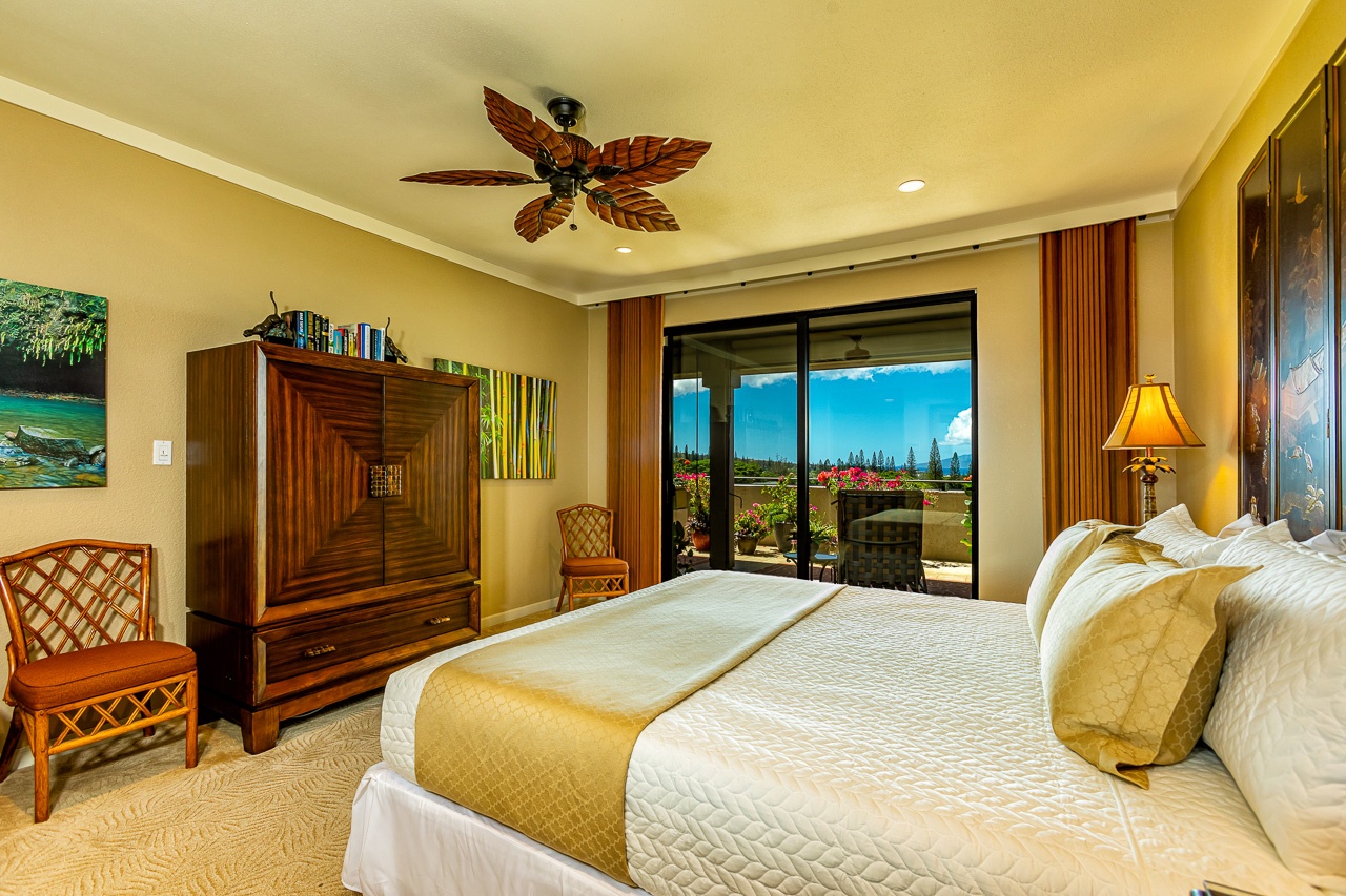 Step into your serene retreat where a plush bed awaits you beneath tropical ceiling fans, with sliding doors opening to the lanai.