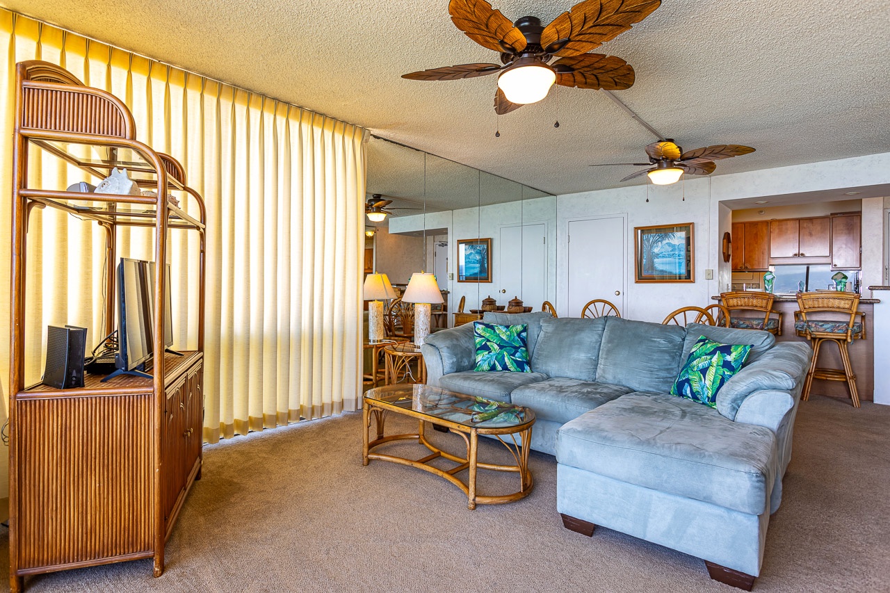 Relax on the plush sectional while tropical ceiling fans keep you cool, surrounded by warm island-style furnishings and plenty of natural light.