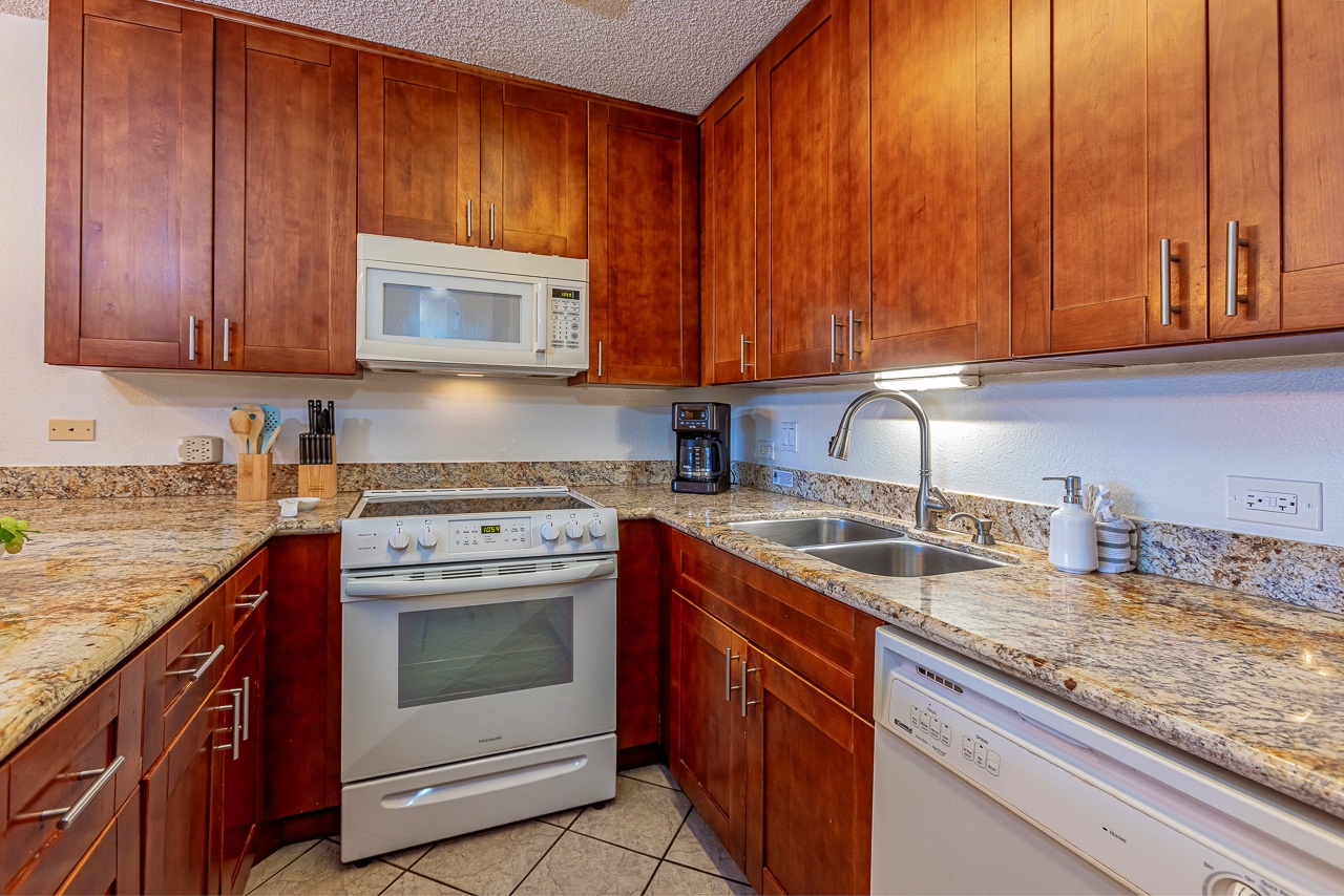 Everything you need for a home-cooked meal awaits in this thoughtfully equipped kitchen, with gleaming countertops, modern appliances, and plenty of storage for your culinary adventures.