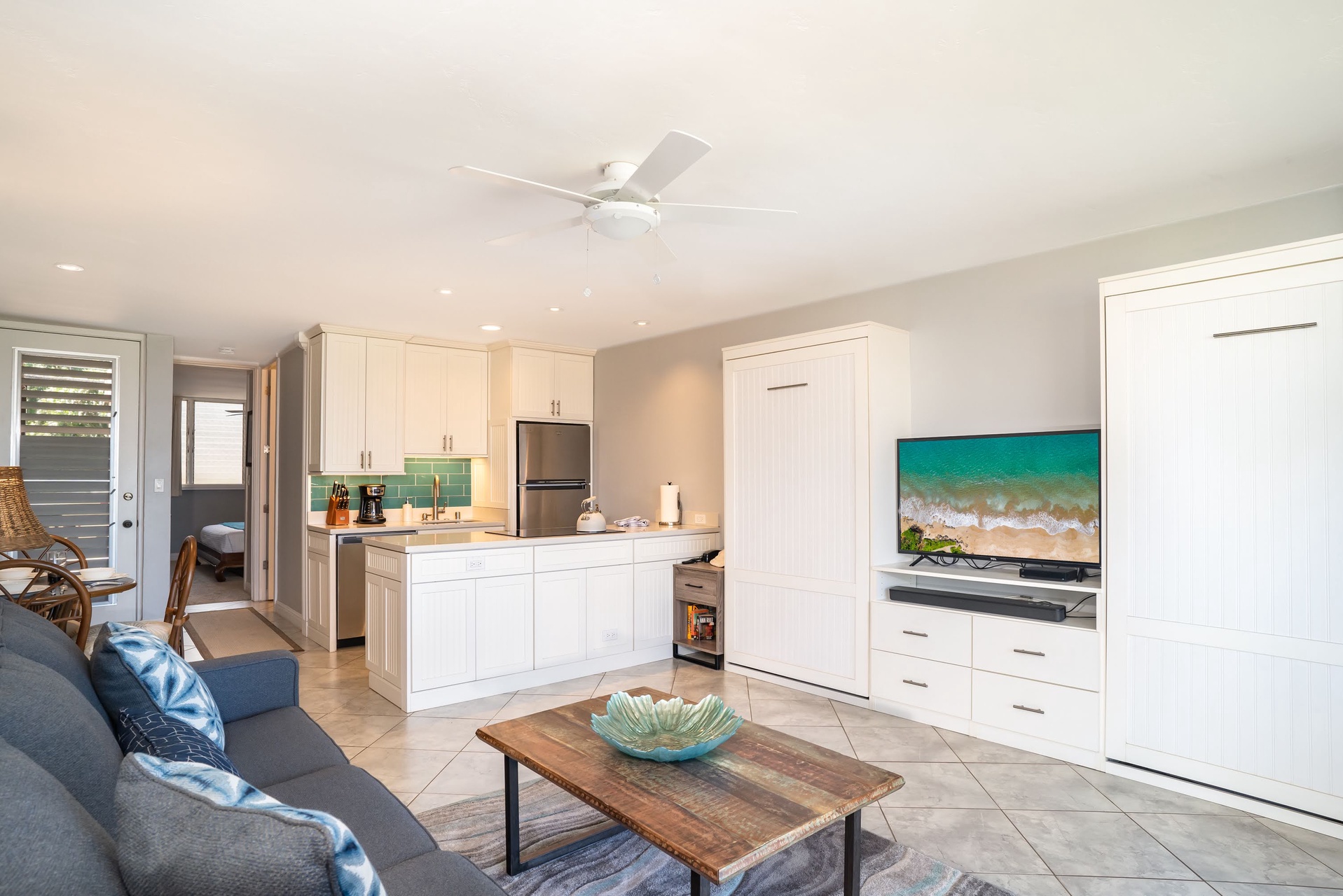 The bright, open space flows seamlessly from living to kitchen. Cook with ease, unwind on the couch, and let beachside relaxation begin.