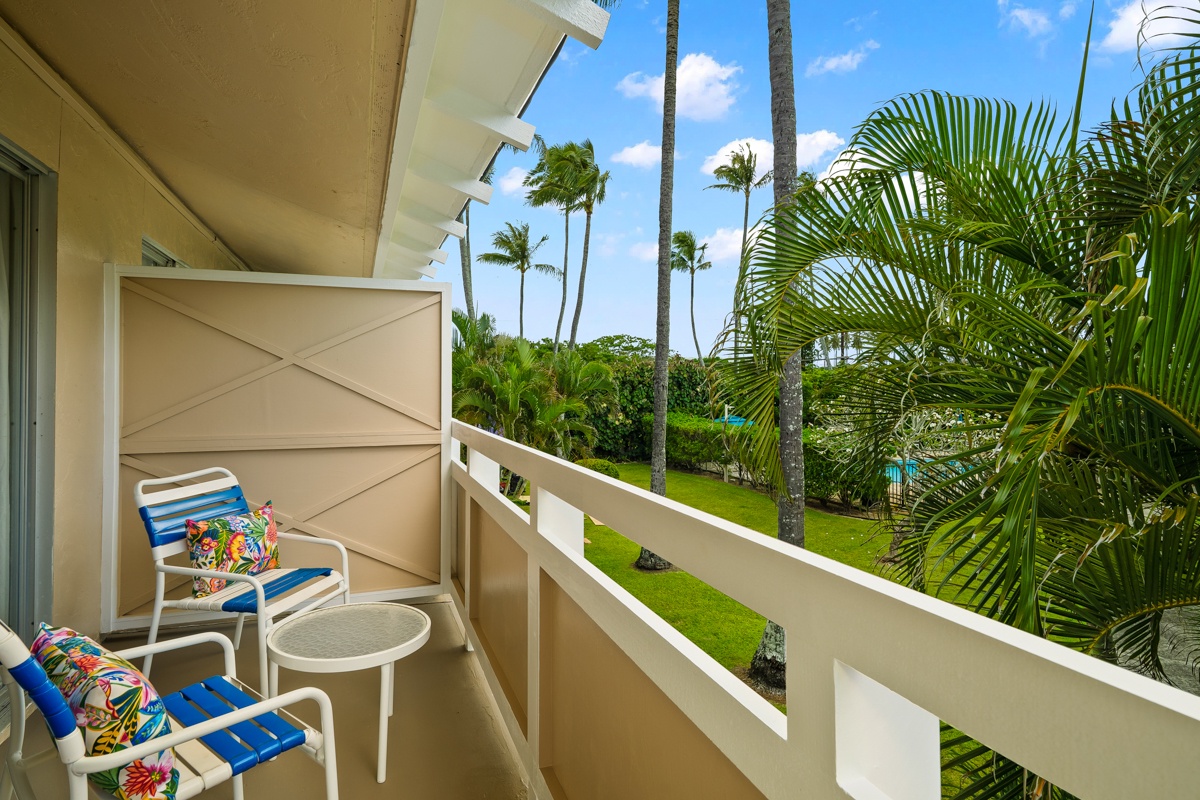 A private lanai with views of tropical gardens and swaying palms frames the lush, manicured grounds below—your serene escape to unwind outdoors.