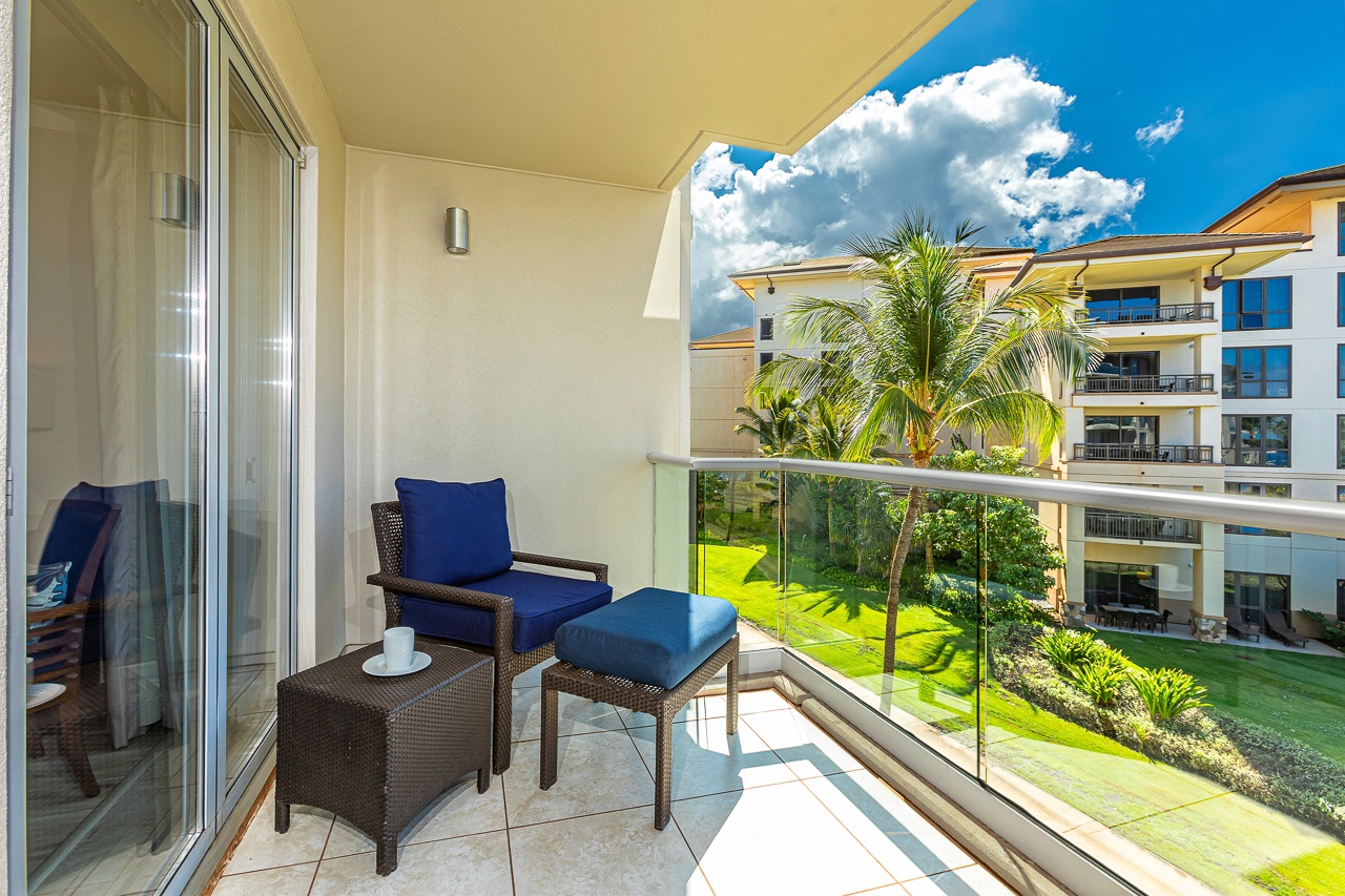 Settle into your private balcony oasis, where lush tropical gardens and towering palms frame the perfect spot for morning coffee under endless blue skies.