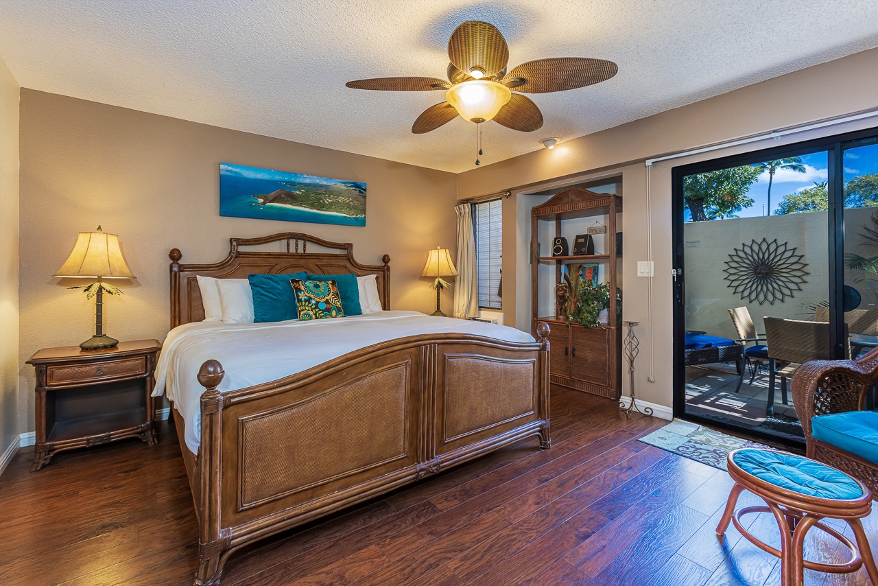Unwind in your tropical-inspired bedroom with rich hardwood floors, warm lighting, and direct private lanai access.