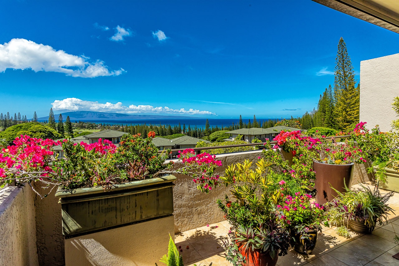 Step out onto your private balcony, where vibrant tropical blooms frame sweeping ocean views and distant islands create a stunning, serene backdrop for your island escape.