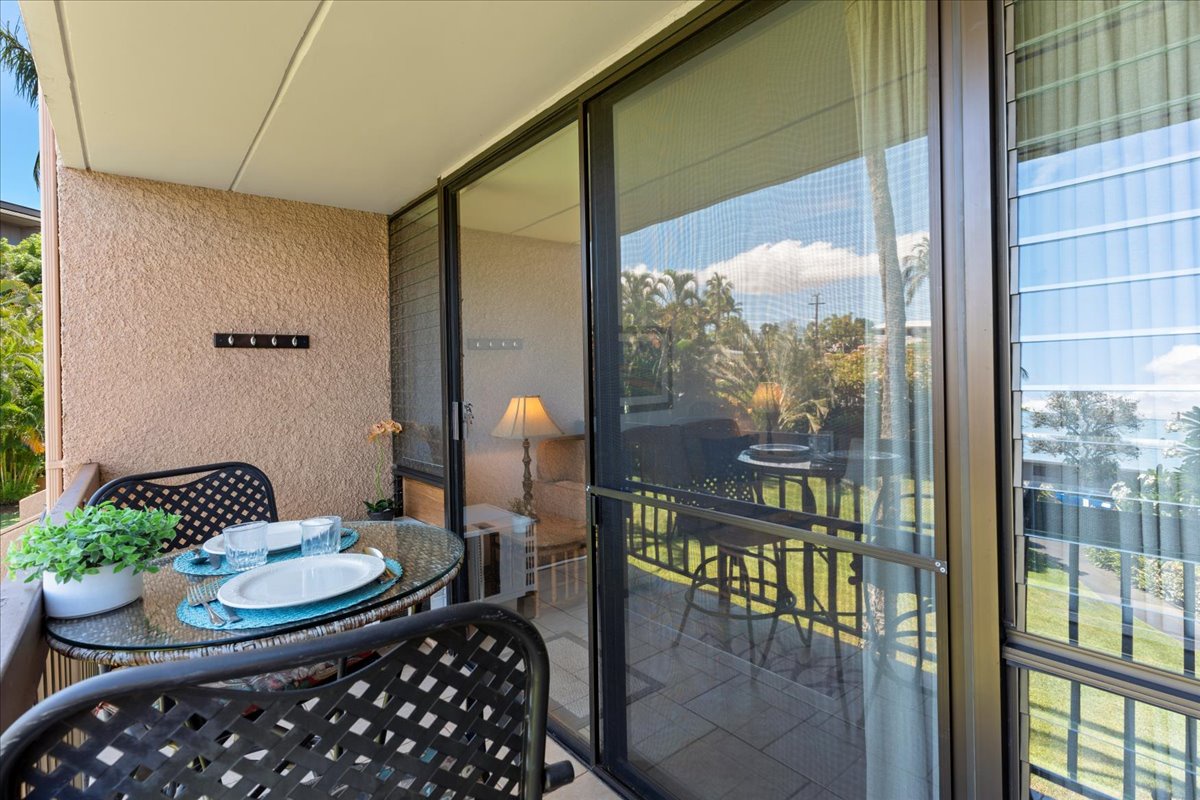 Your private outdoor dining space overlooks tropical greenery and sparkling ocean beyond. Enjoy morning coffee or sunset meals at your own table, with the gentle island breeze all around you.