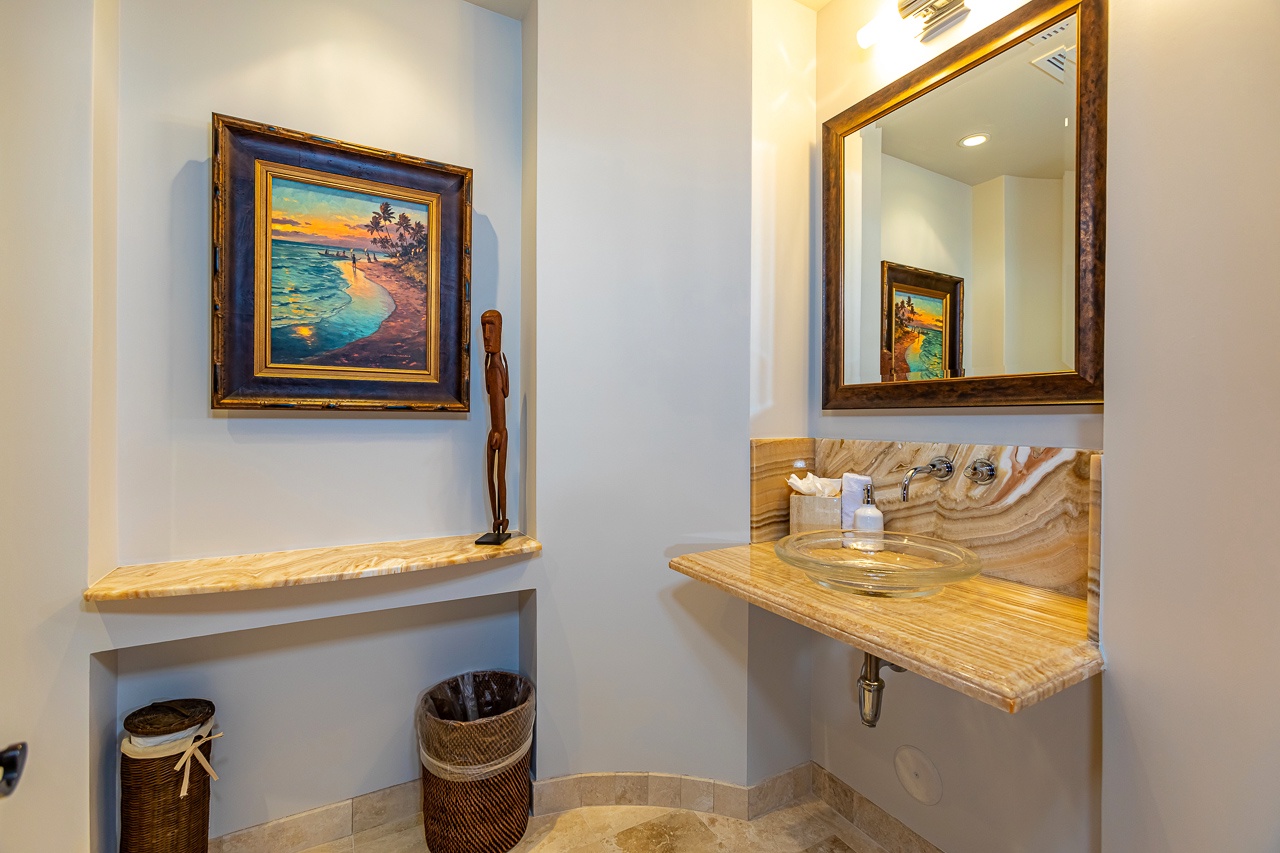 Refresh in your stylishly appointed bathroom with custom wood finishes, a glass vessel sink, and thoughtful amenities waiting for you.
