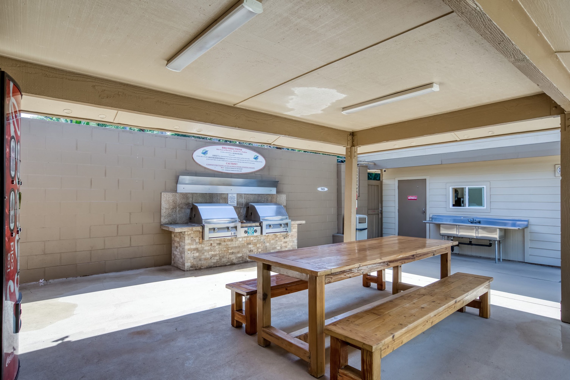 Communal barbecue pavilion and dining area with built-in grills and picnic seating for outdoor gatherings.