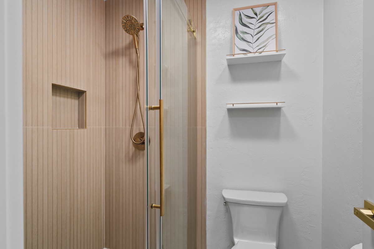 A bright, modern bathroom featuring a sleek walk-in shower.