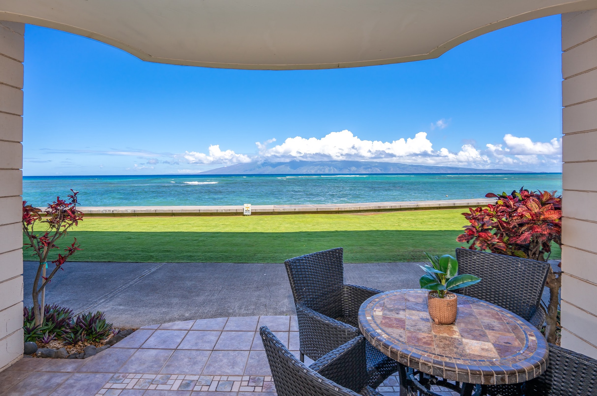 Wake up to this stunning oceanfront view, just steps from your private patio. The brilliant turquoise waters and manicured lawn create a perfect backdrop for morning coffee or sunset relaxation.