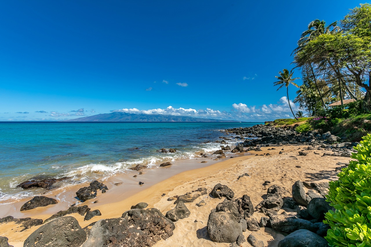 A peaceful Hawaiian beach sits just steps from the property.