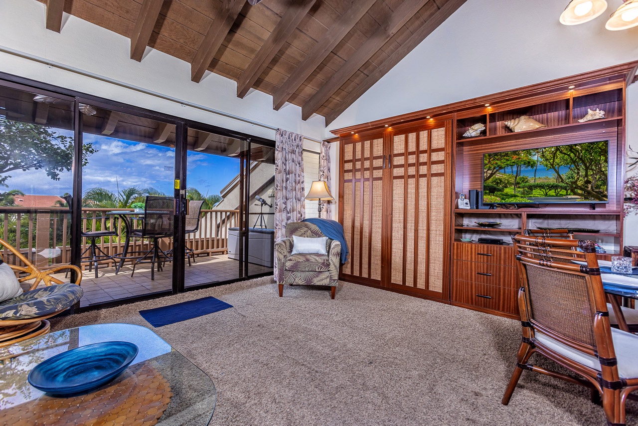 Step into your inviting living space with beautiful vaulted wood beam ceilings and direct access to your private lanai, where you can relax and soak in the tropical surroundings.