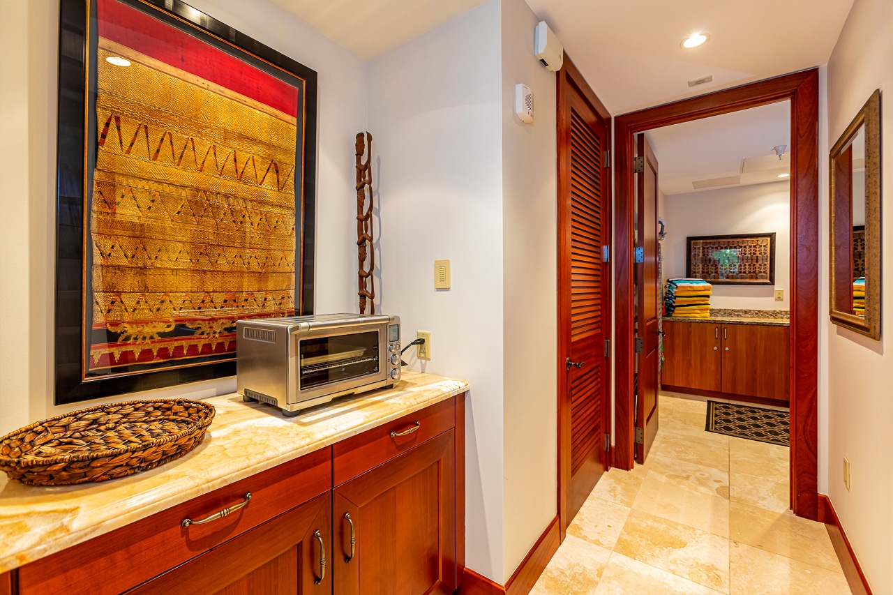 Step into your private retreat where rich wood tones and vibrant local artwork create a warm, inviting atmosphere. Your kitchenette is ready for morning coffee or quick snacks.