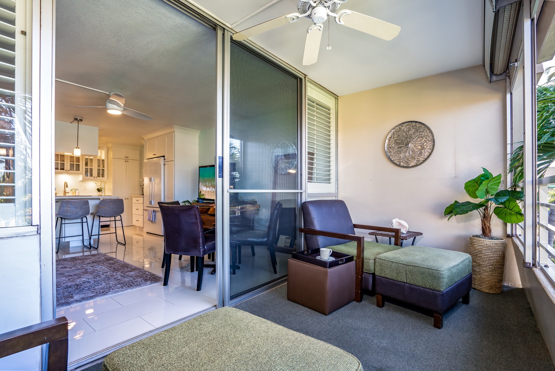 Your private screened lanai offers a peaceful spot to sip morning coffee or unwind, with tropical breezes and open views into the bright, fully-equipped kitchen.