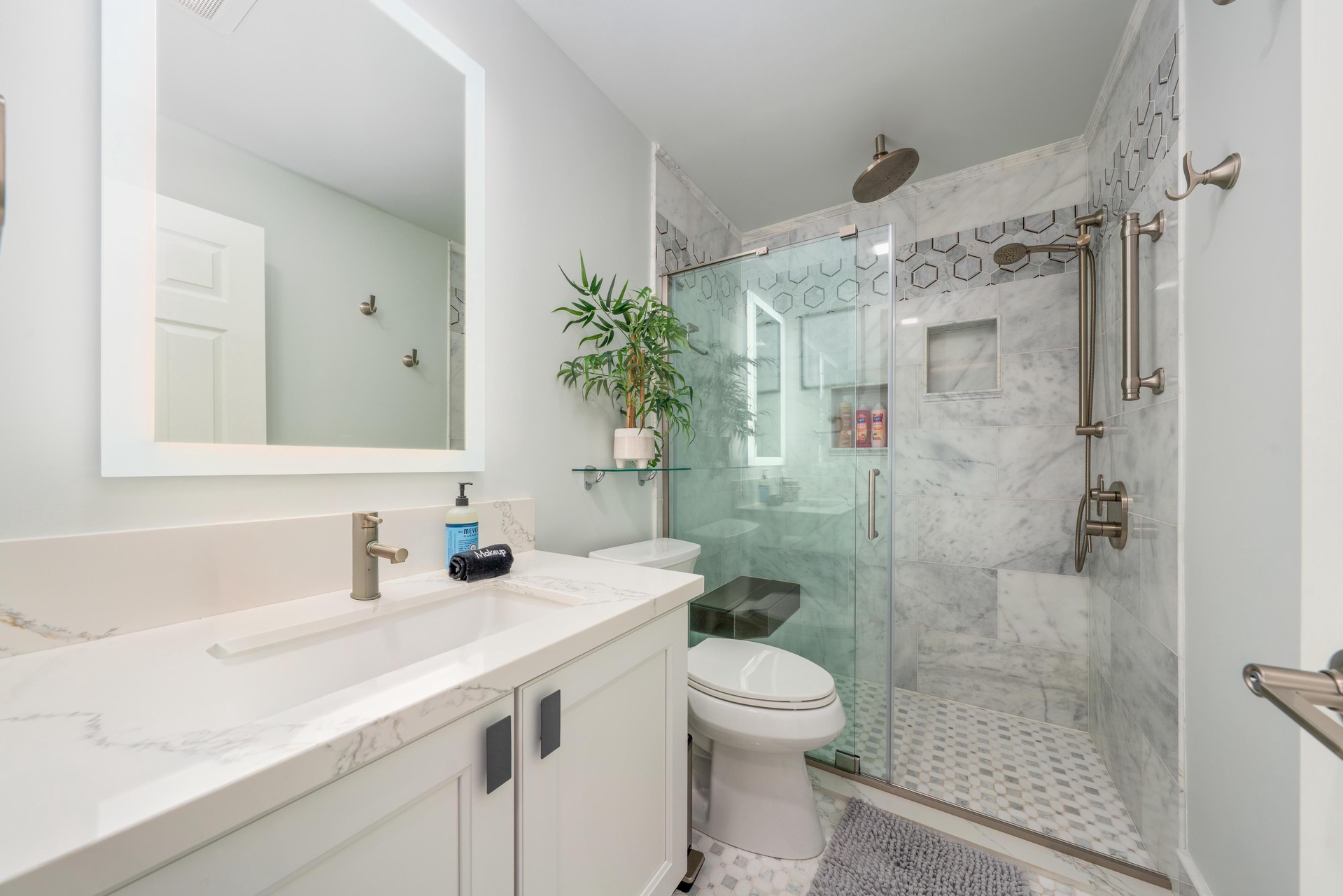 Step into your luxurious marble bathroom featuring a spacious glass shower, elegant hexagonal tile accents, and premium finishes for your ultimate comfort.