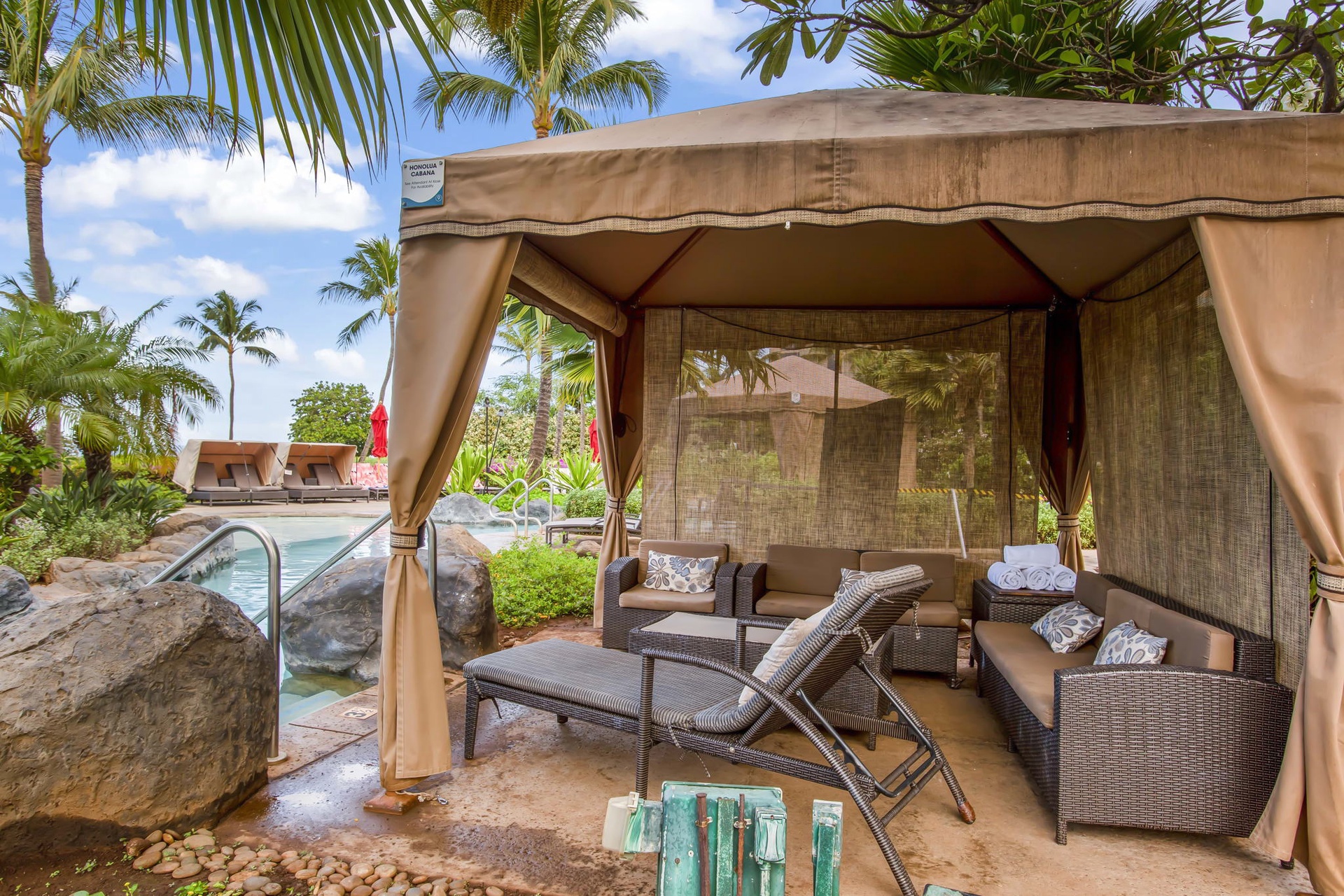 Your private poolside cabana awaits, complete with plush seating and tropical breezes.