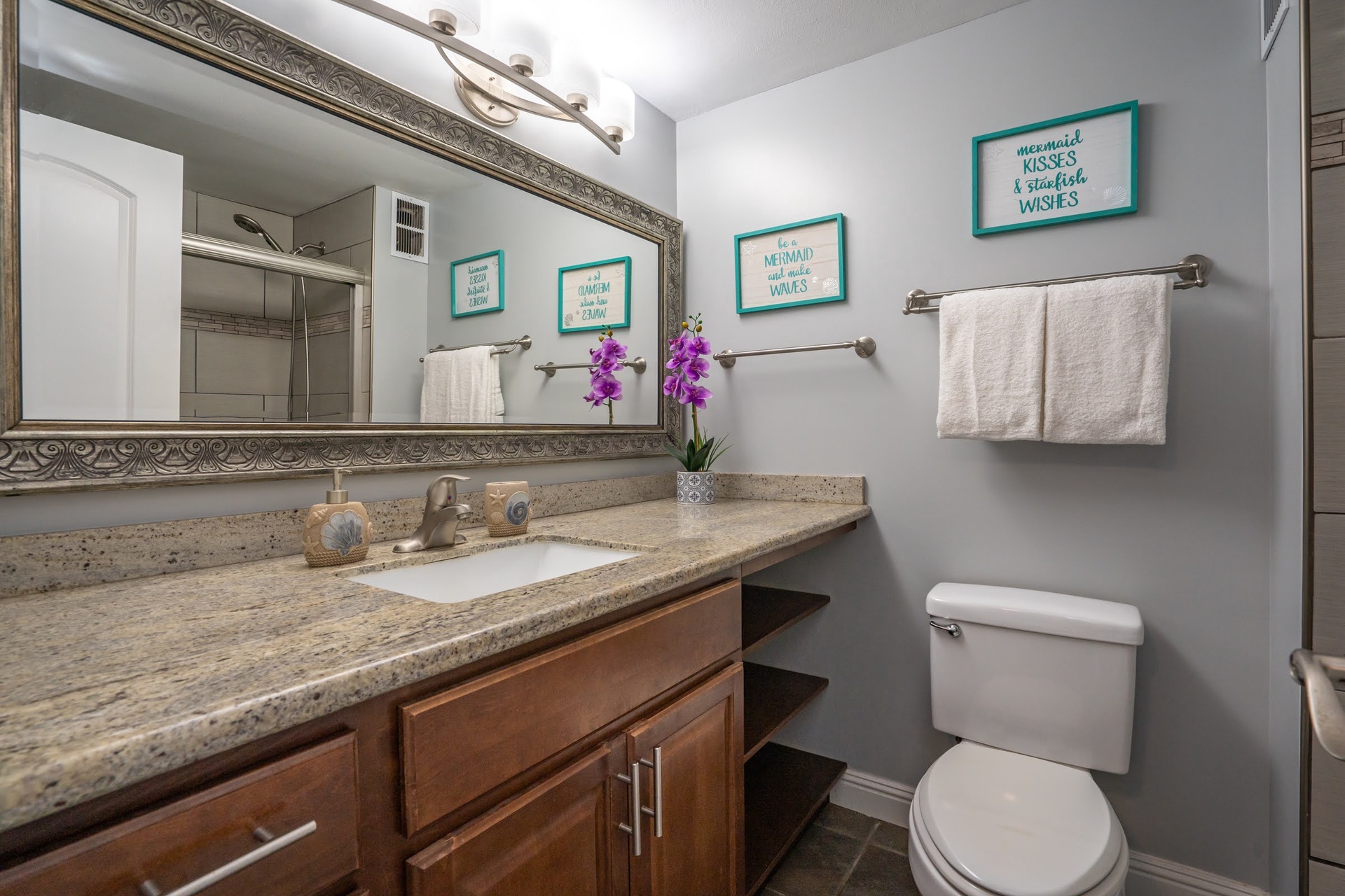 Step into your private bathroom, where soft linens, granite countertops, and coastal-inspired touches create a soothing retreat.