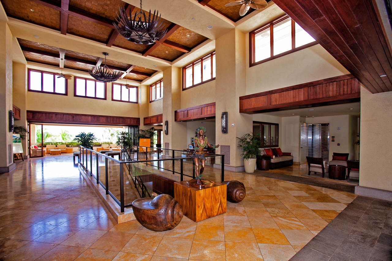 Step into a stunning lobby where soaring wood-beam ceilings, warm natural light, and island-inspired art set a welcoming tone for your tropical escape.