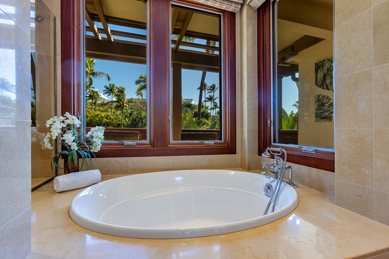 Soak in your private tub and gaze at swaying palms and tropical gardens through open windows—pure island tranquility at your fingertips.