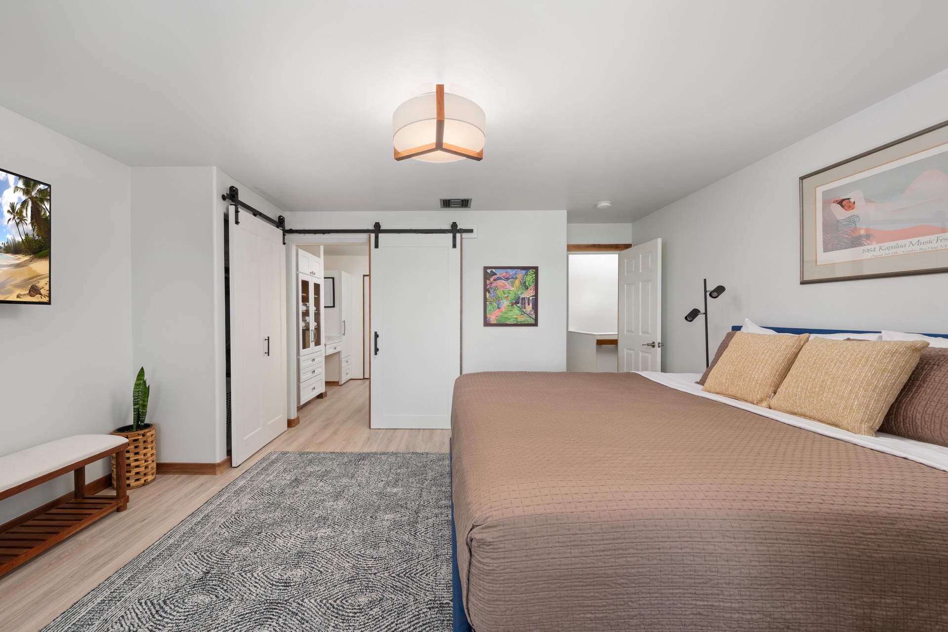 Unwind in your spacious master bedroom with stylish barn doors, warm lighting, and calming neutral tones creating the perfect retreat.