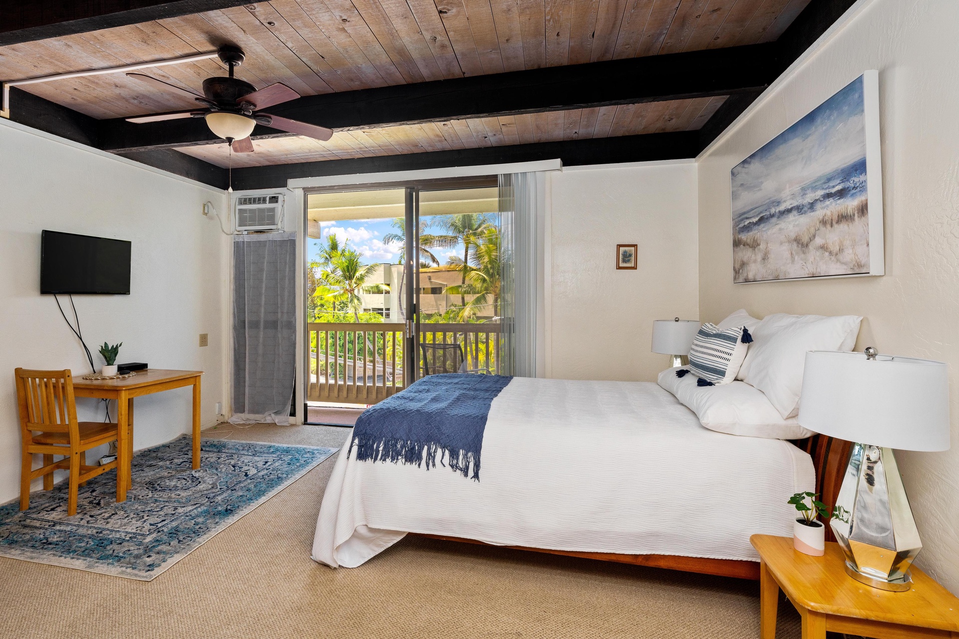 Wake up to swaying palms and island views from your cozy bed, with beamed ceilings overhead and a private balcony just steps away for your morning coffee or evening relaxation.
