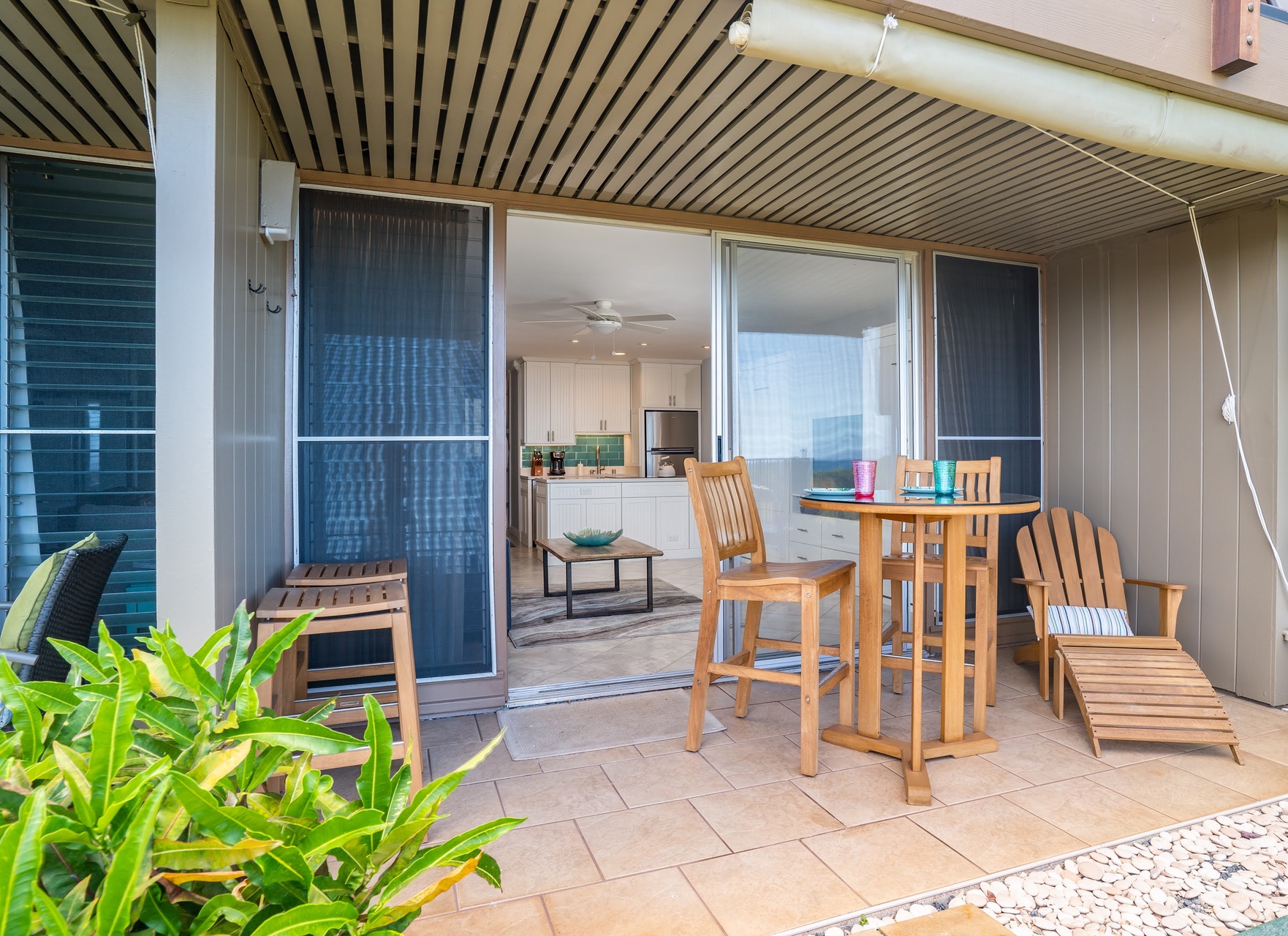 A private covered terrace invites you to dine outdoors with a bistro table and chairs, plus a lounge chair for soaking up island breezes and views.