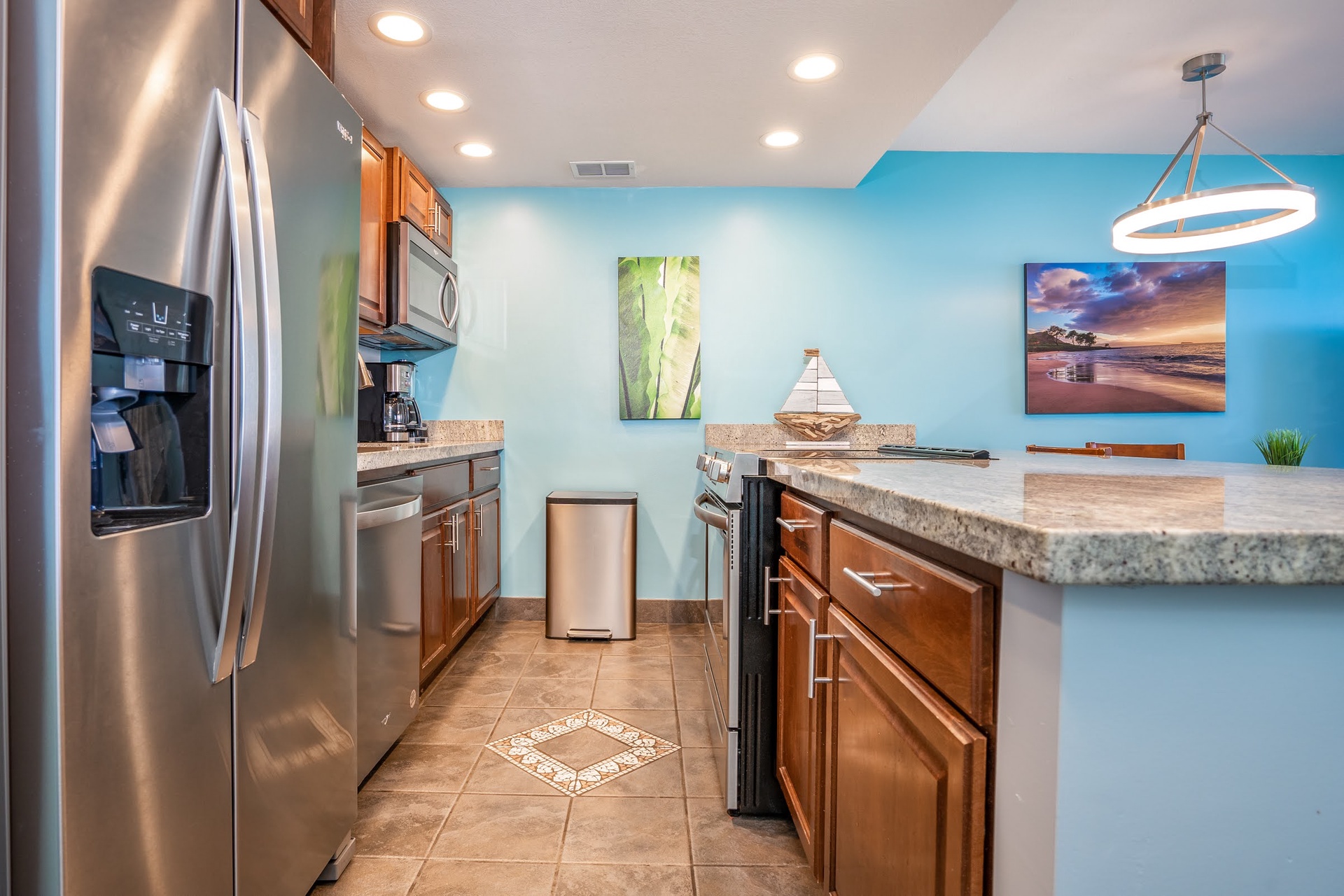 Your kitchen awaits with gleaming stainless appliances, beautiful granite counters, and a cheerful turquoise accent wall to set the mood for effortless vacation cooking and morning coffee rituals.
