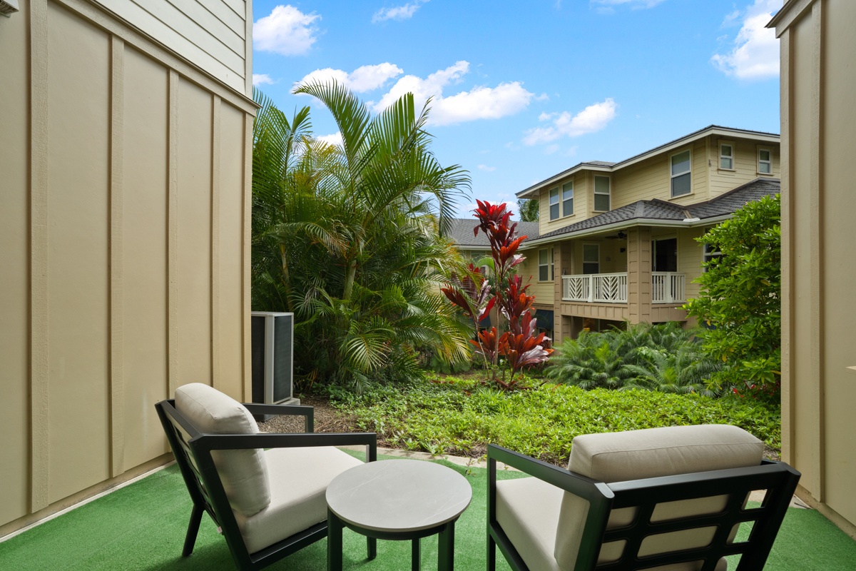 Relax on your private patio while gazing at tropical gardens with vibrant palm trees and colorful plants.