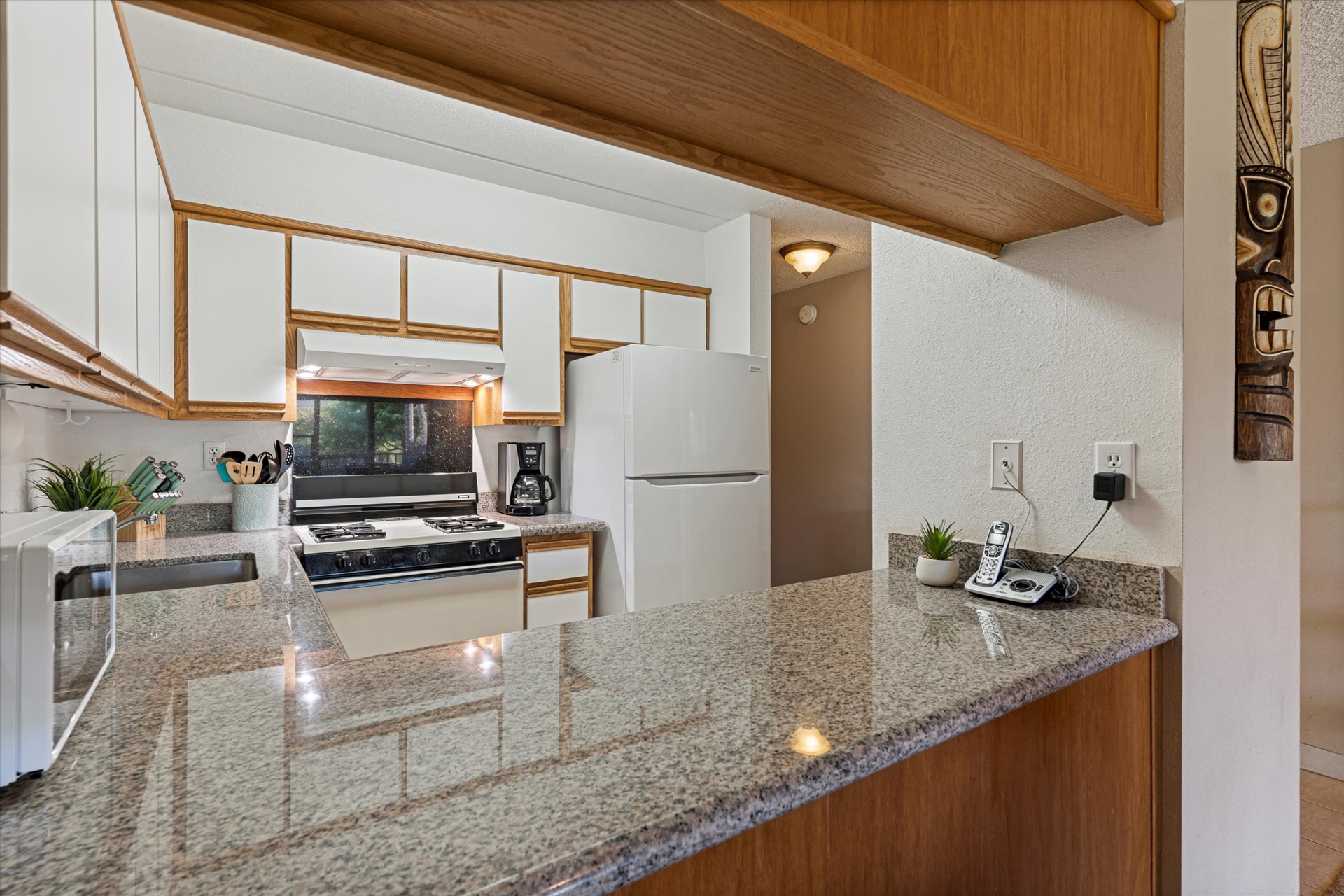 Your fully equipped kitchen awaits with granite counters, a gas stove, and everything you need to cook up memorable vacation meals together.