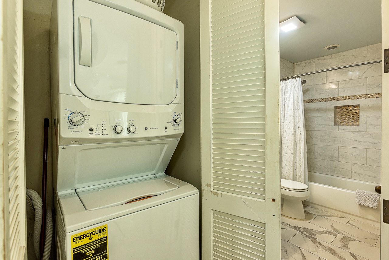 Your vacation rental includes convenient in-unit laundry facilities, so you can pack light and freshen up anytime. The modern bathroom features elegant tile work and a spacious walk-in shower for your comfort.