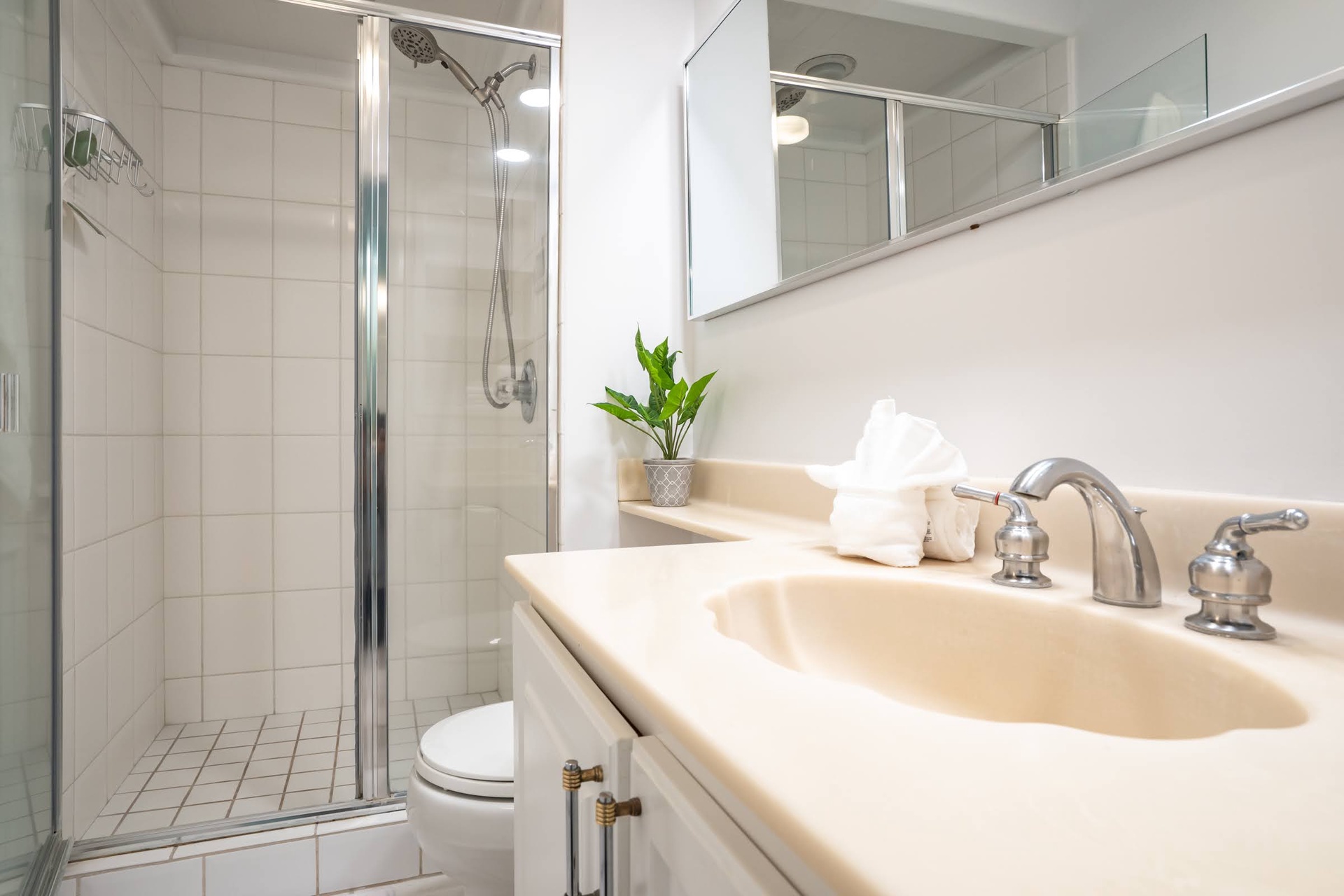 Your private bathroom features a spacious walk-in shower, fresh towels, and a thoughtfully appointed vanity—everything you need for a refreshing start to your day.