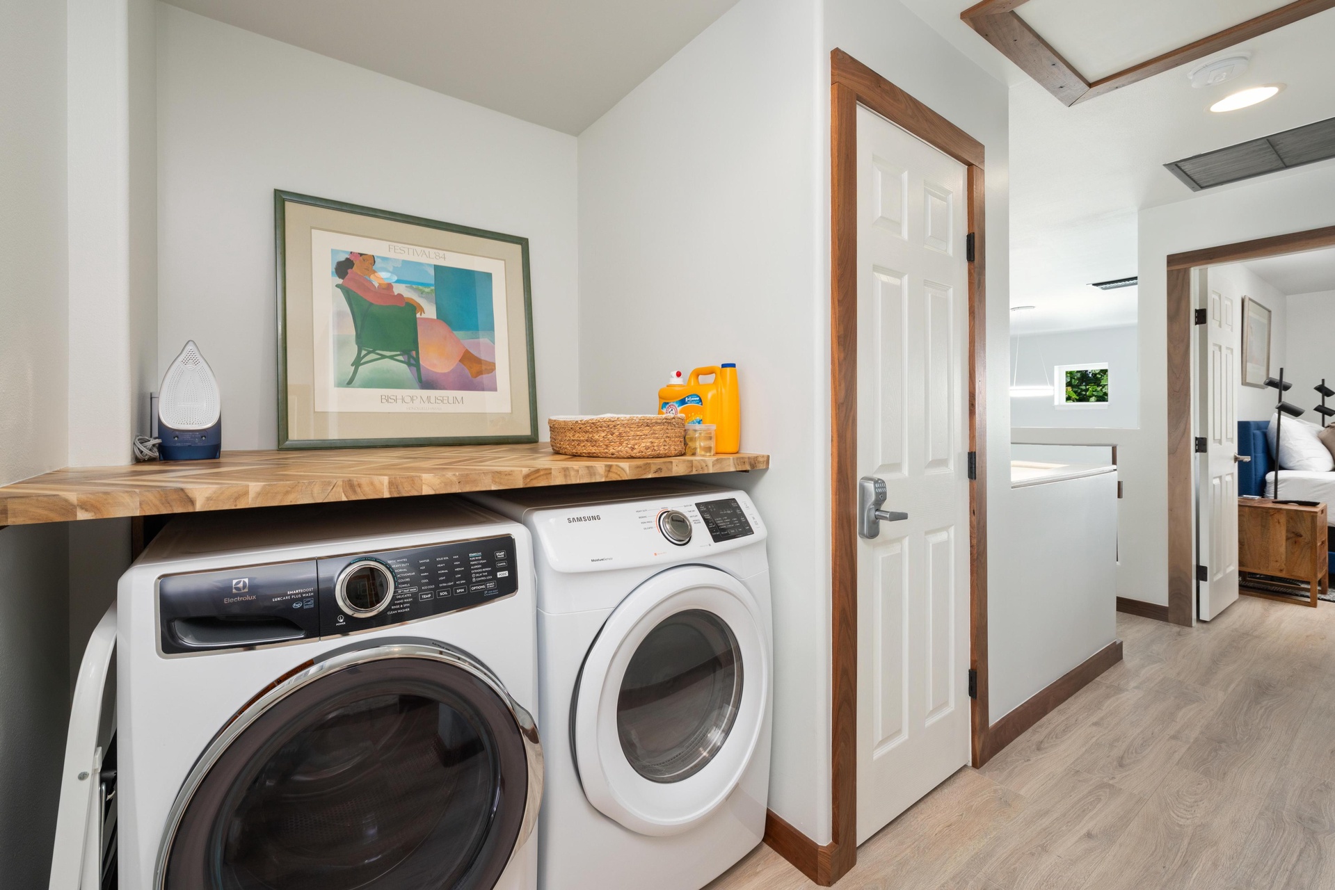 Your laundry day just got luxurious with full-size washer and dryer beneath a warm wood shelf for your essentials.
