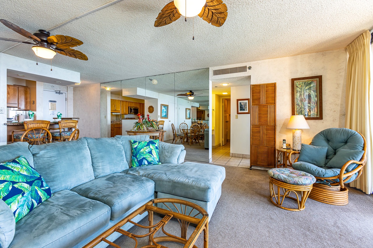 Relax in your spacious tropical retreat, where plush seating, cheerful leaf-blade ceiling fans, and island-inspired touches create a breezy, welcoming atmosphere for unwinding after a day of adventure.