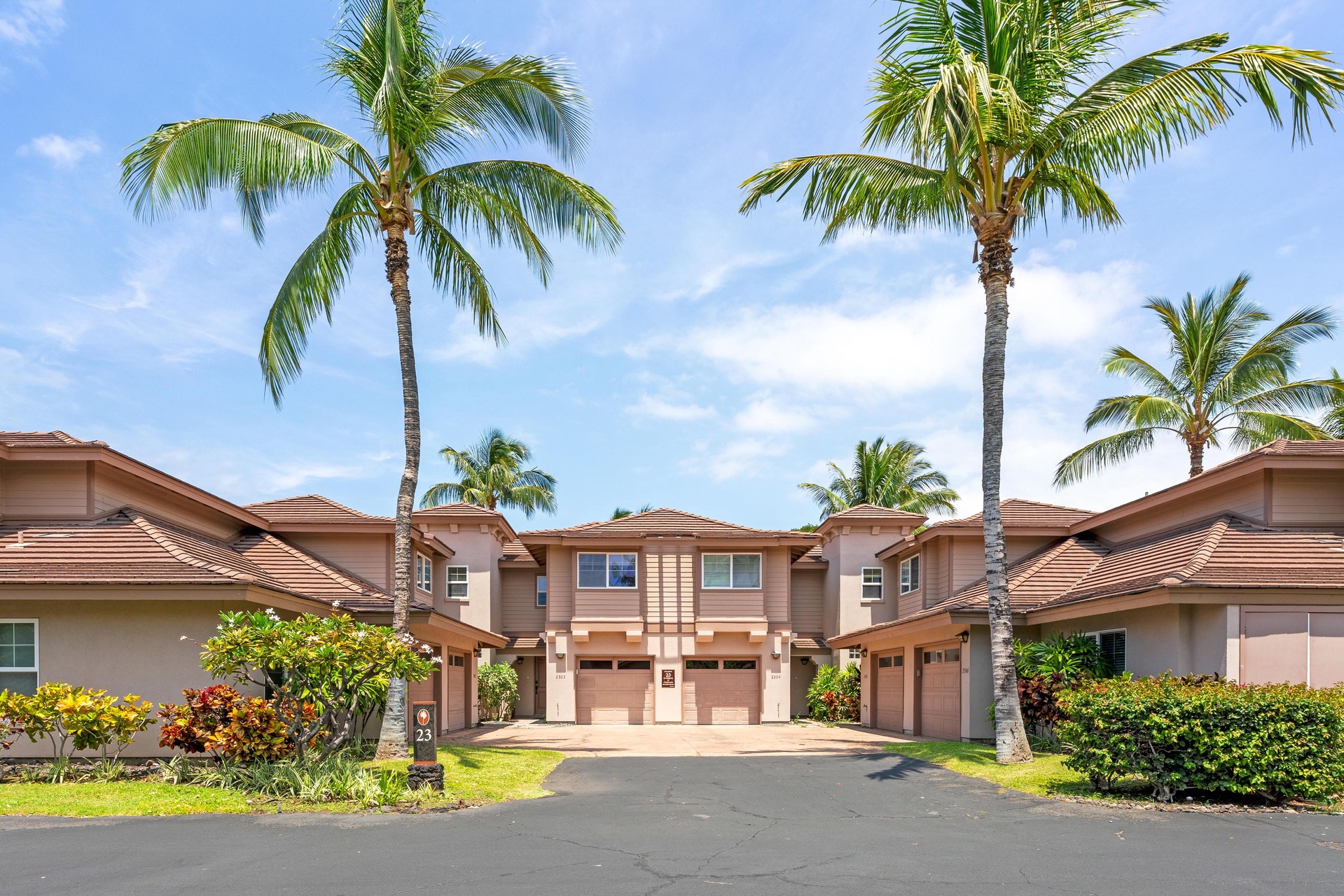Tropical paradise awaits at this beautiful resort community, where swaying palm trees frame elegant townhomes in a serene Hawaiian setting.