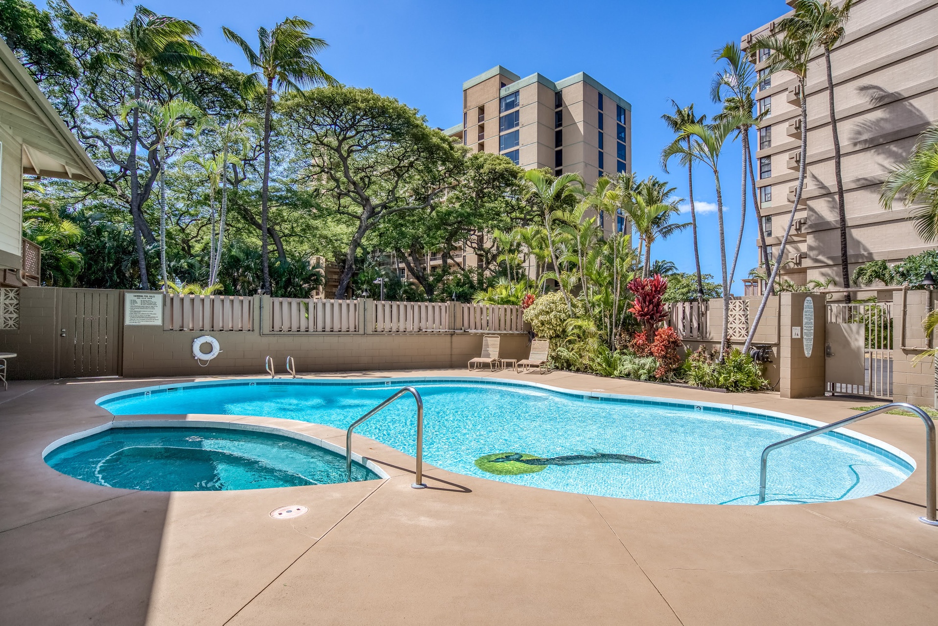Soak up the sunshine beside your private pool surrounded by lush tropical palms and vibrant island gardens, perfect for lazy afternoons unwinding in paradise.