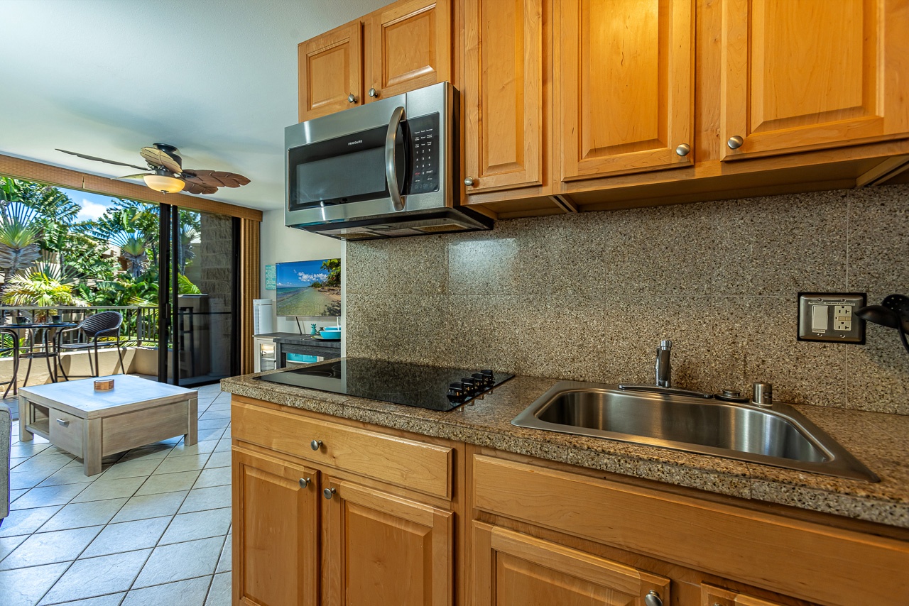 Your well-equipped kitchen opens to lush tropical surroundings, perfect for preparing meals while feeling the island breeze and enjoying views of swaying palms.
