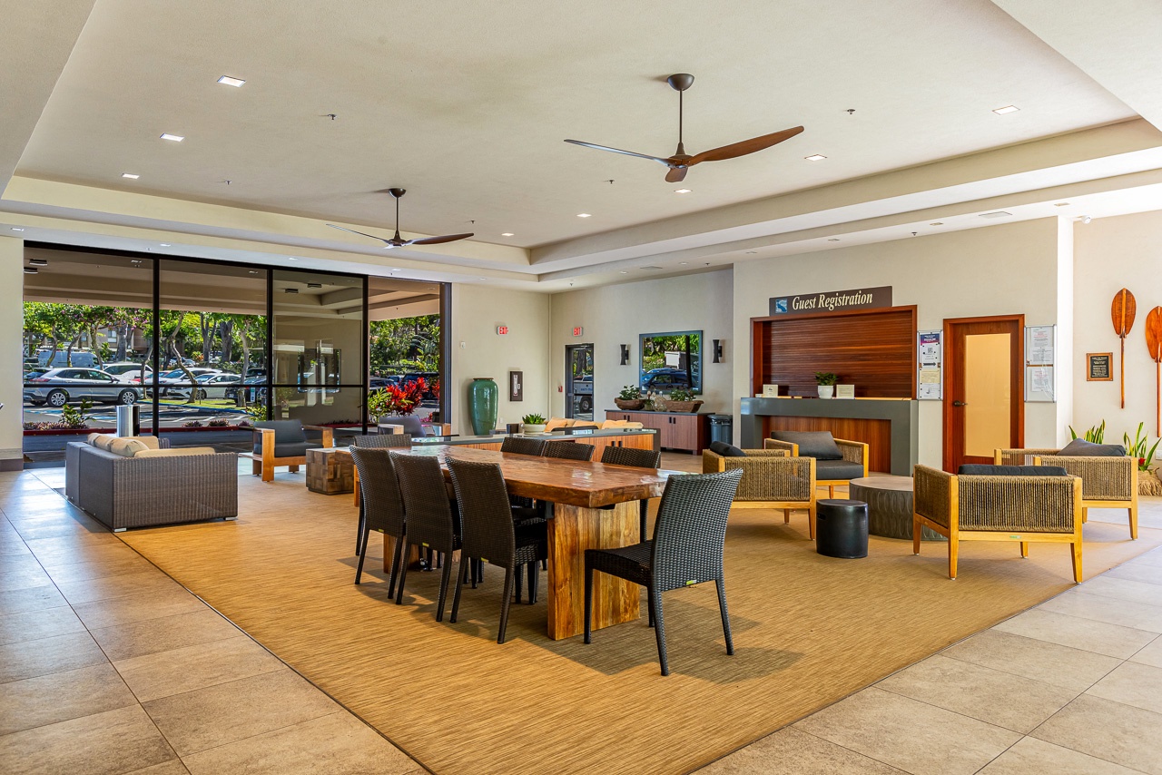 Step into your welcoming lobby where natural light floods through floor-to-ceiling windows, illuminating warm wood accents and comfortable seating areas perfect for planning your island adventures.