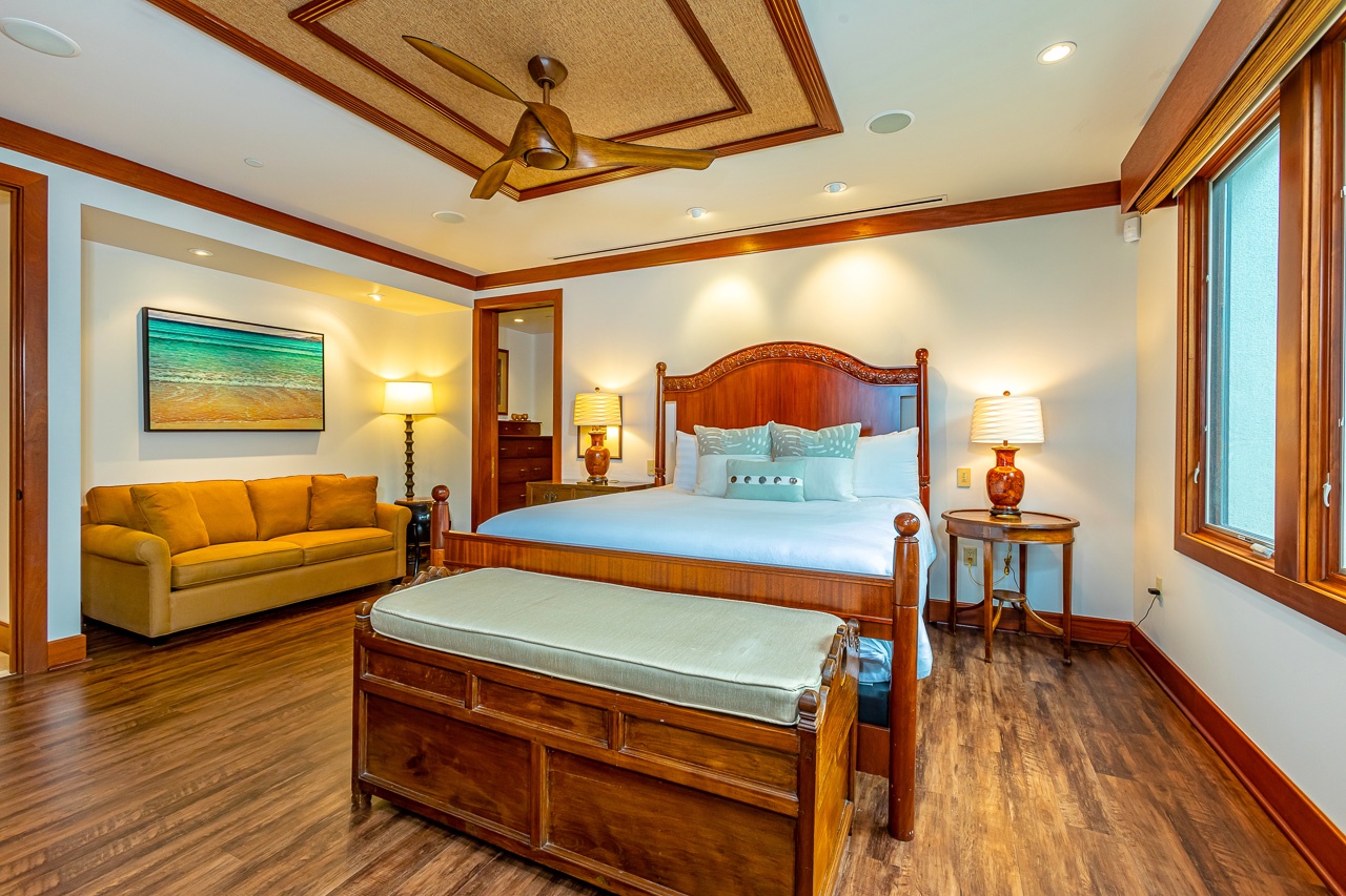 Step into your spacious bedroom retreat, where rich wood tones and elegant coastal decor create a warm, inviting atmosphere. Relax on the plush king bed or unwind on the cozy sitting area sofa as soft island breezes flow through.