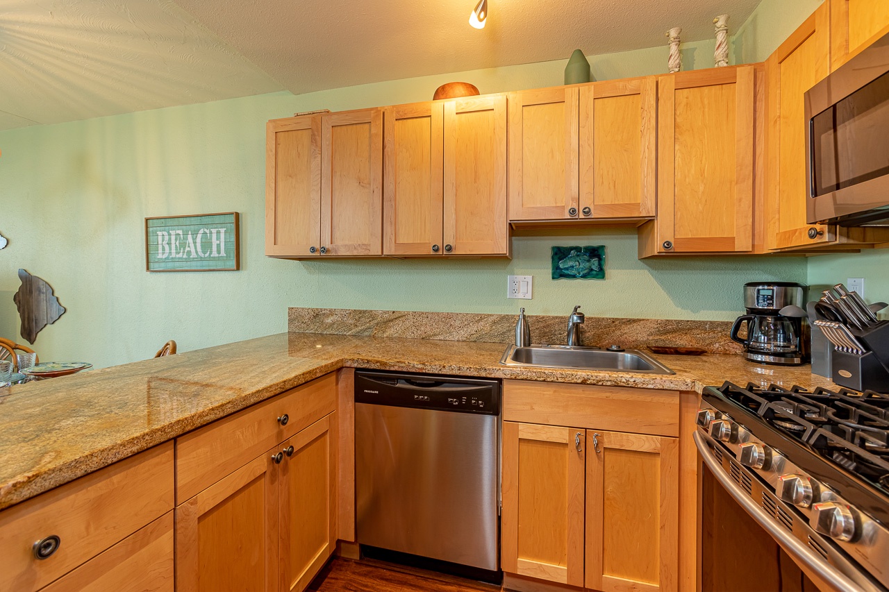 Bright kitchen featuring updated stainless appliances