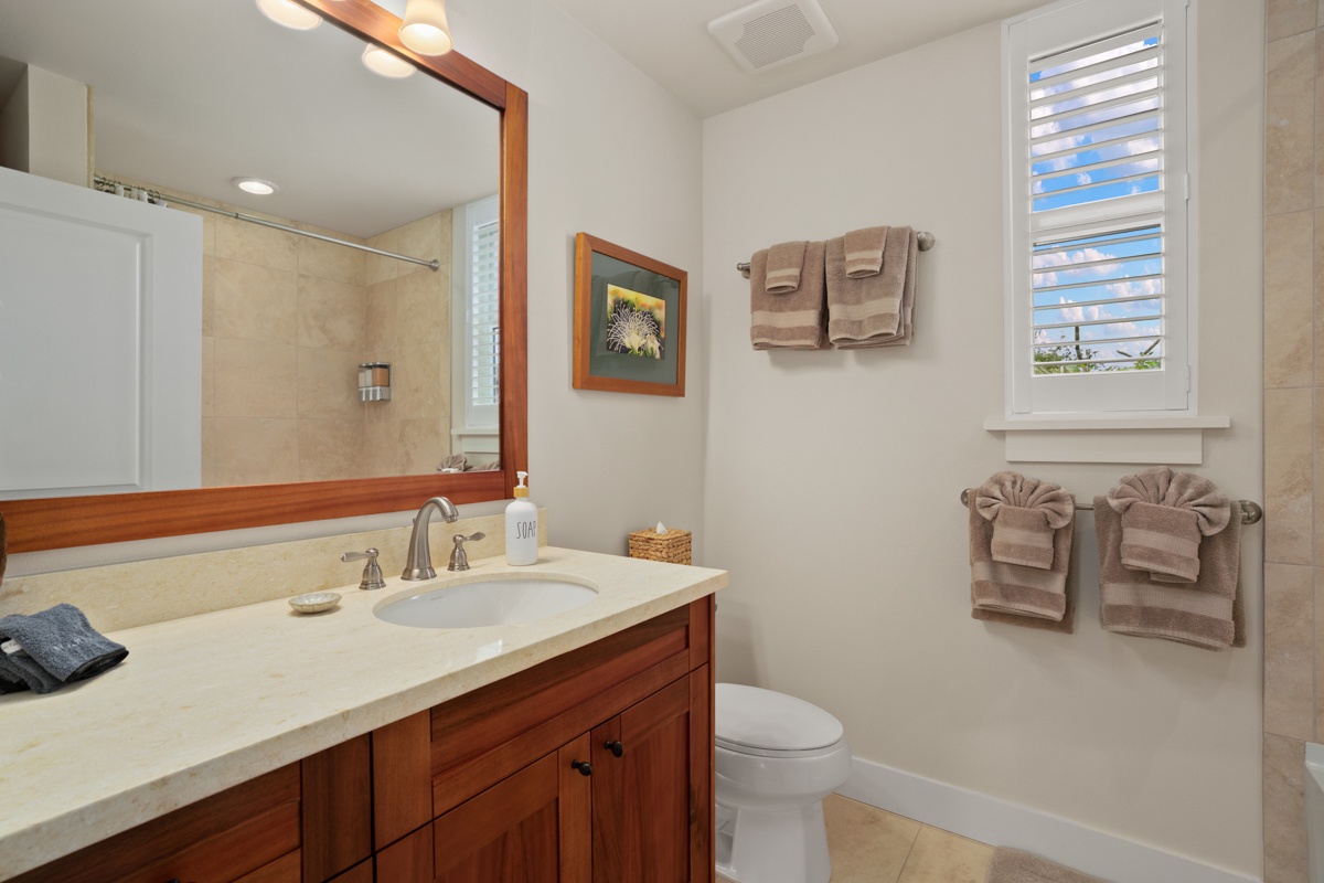 Guest bedroom ensuite bath with shower/tub combo.
