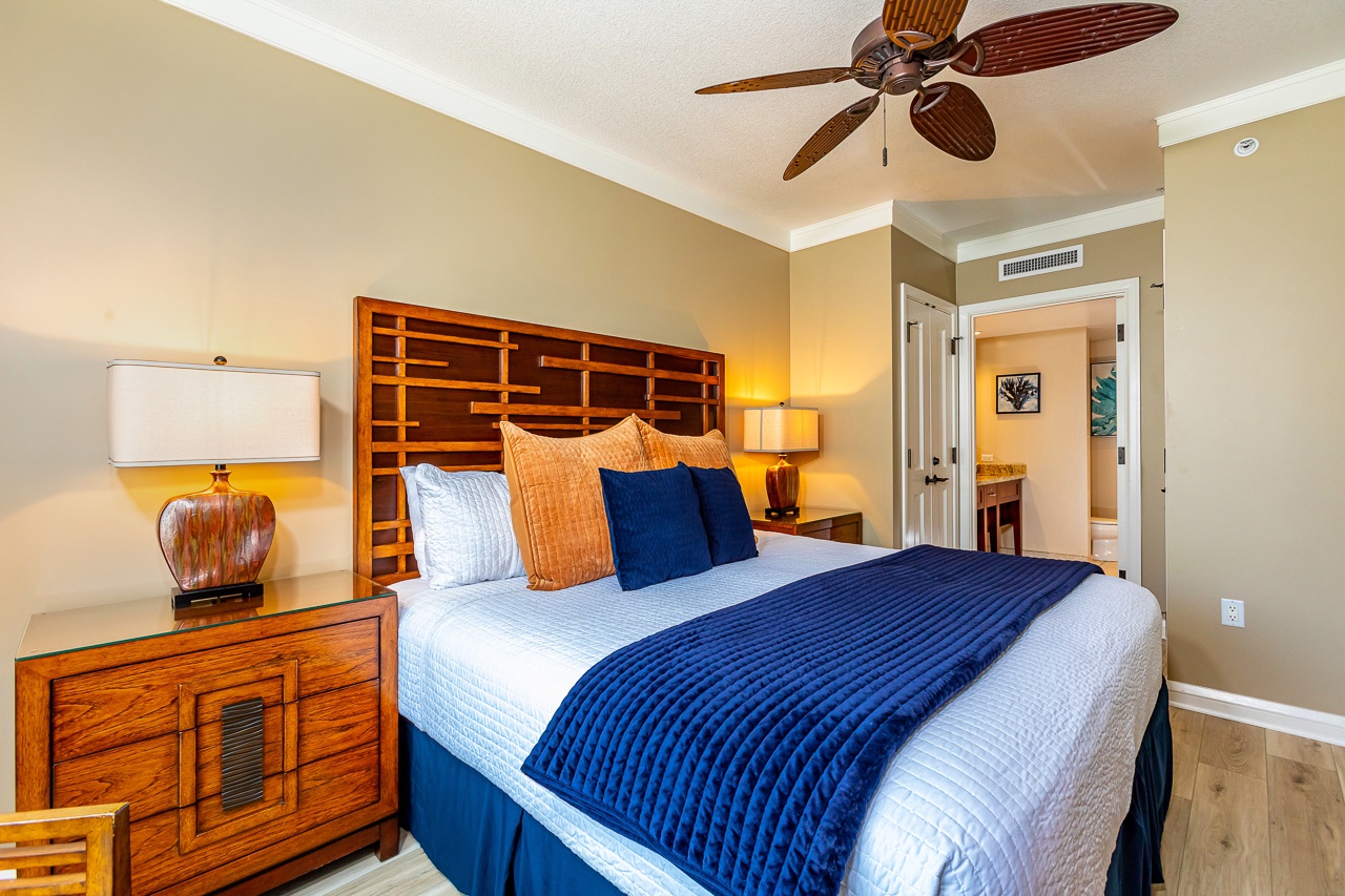 Sink into crisp white linens and tropical-inspired comfort in your beautifully appointed guest bedroom. The warm woods and ceiling fan create the perfect coastal retreat for restful nights.