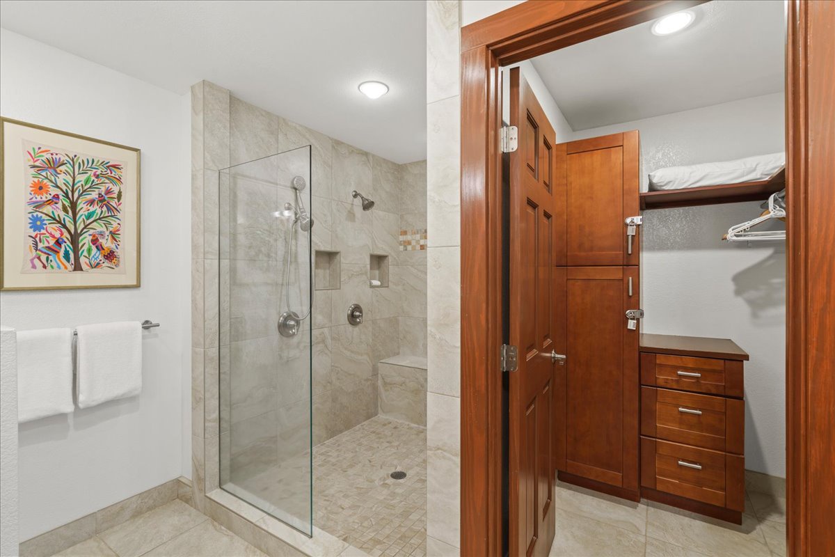 Spacious primary bathroom with a large walk in shower and dual shower heads
