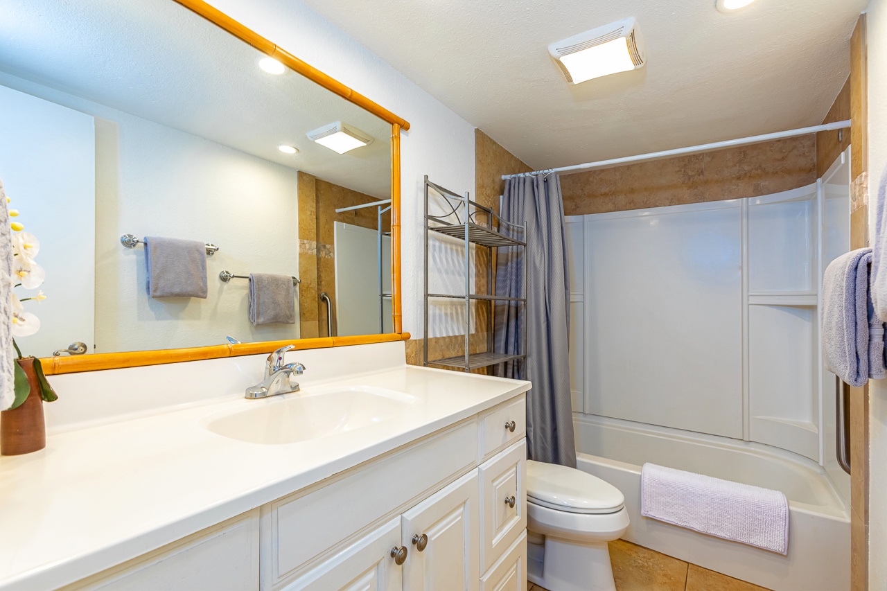 Step into your bright, spotless bathroom, where plush towels and a sparkling tub/shower combo await.