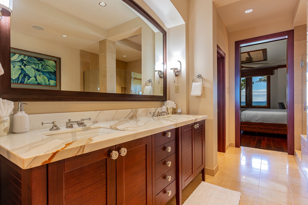 Step into your spa-like ensuite with a stunning marble double vanity and warm wood cabinetry. Through the doorway, the master bedroom opens to breathtaking ocean vistas.