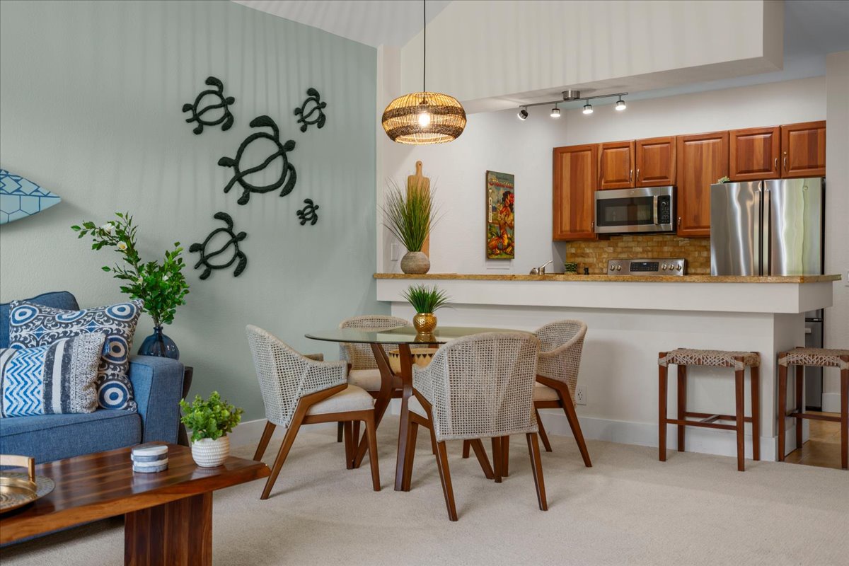 Your bright open-concept living space blends relaxation and function, with coastal-inspired décor, a fully equipped kitchen, and a cozy dining area perfect for enjoying meals together.
