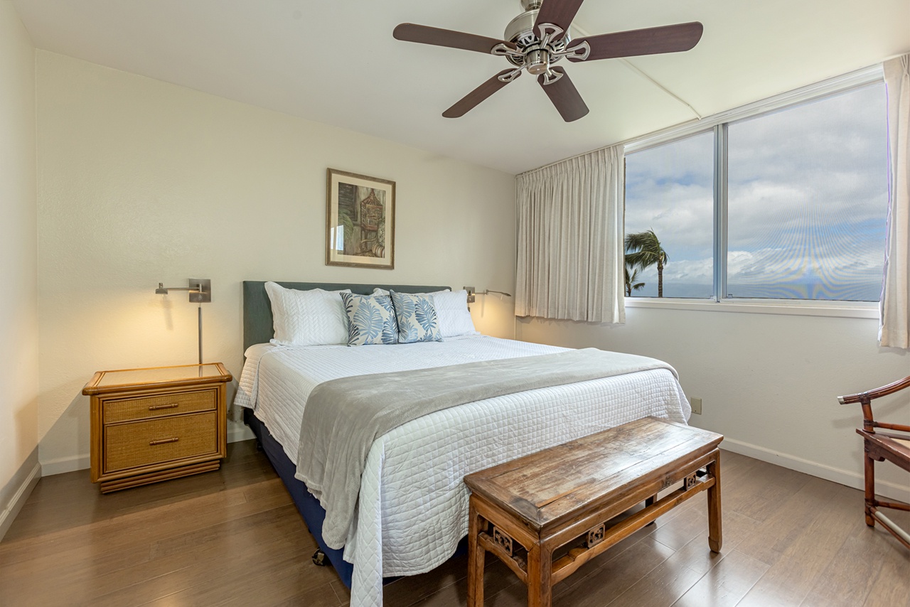 Relax in your serene bedroom with crisp linens, tropical accents, and soothing ocean views. Gentle ceiling fan breezes and soft bedside lighting create a peaceful retreat.