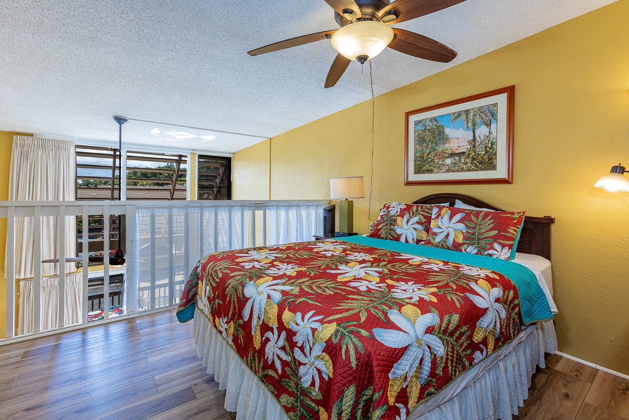 Bright upstairs bedroom with a queen bed and tropical touches
